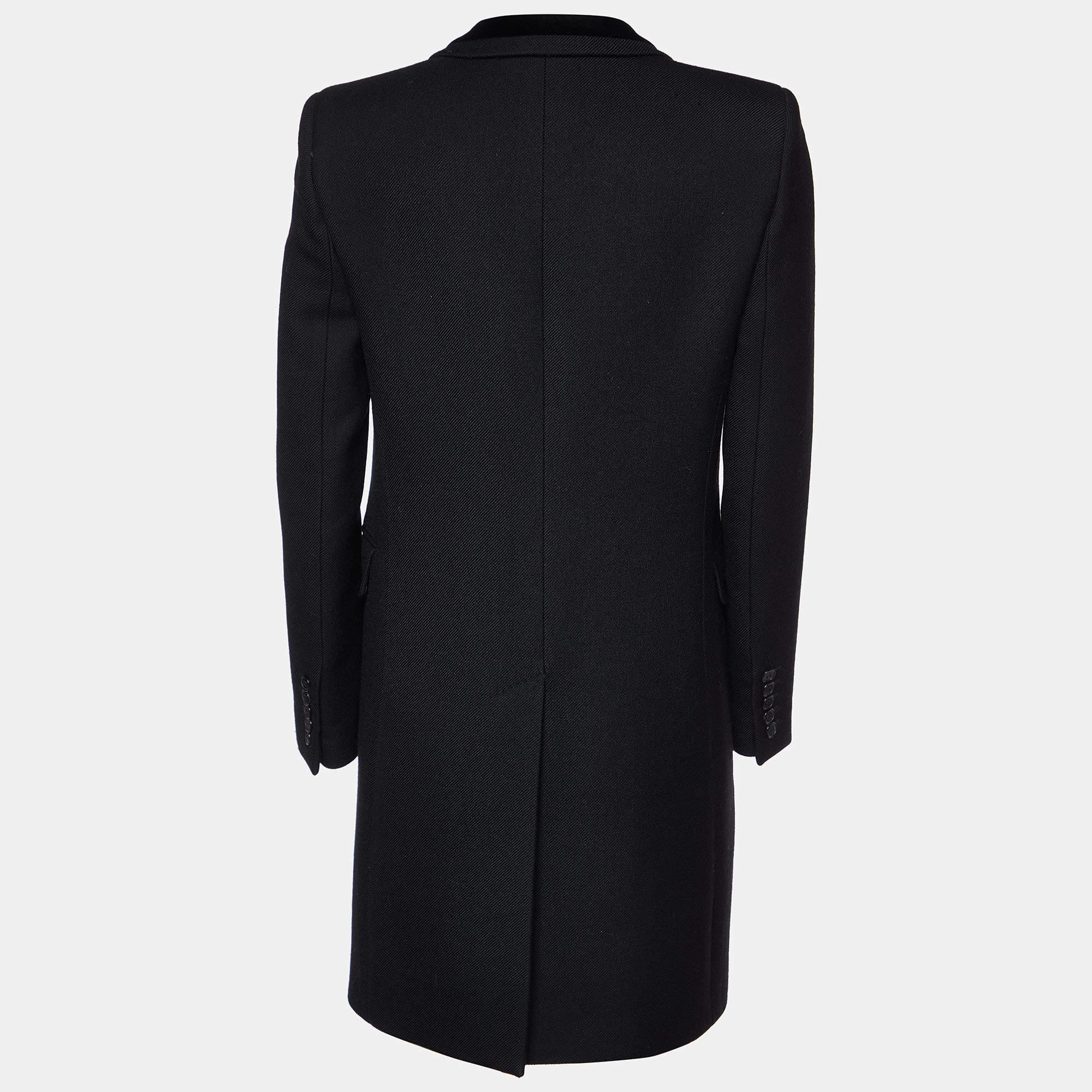 Crafted from luxurious black wool, this Saint Laurent mid-length coat exudes timeless style and sophistication. Its tailored silhouette flatters the figure, while the classic lapel collar and button closure add a refined touch. Perfect for chilly
