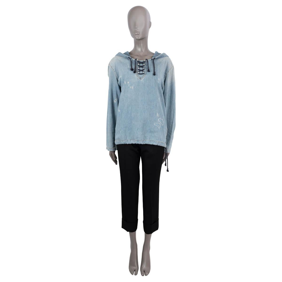 100% authentic Saint Laurent distressed denim hoodie in light blue cotton (100%). Features dropped shoulders, a lace-up front fasting, drawstring hood and bottom hem with a short side zipper. Unlined. Has been worn and is in excellent