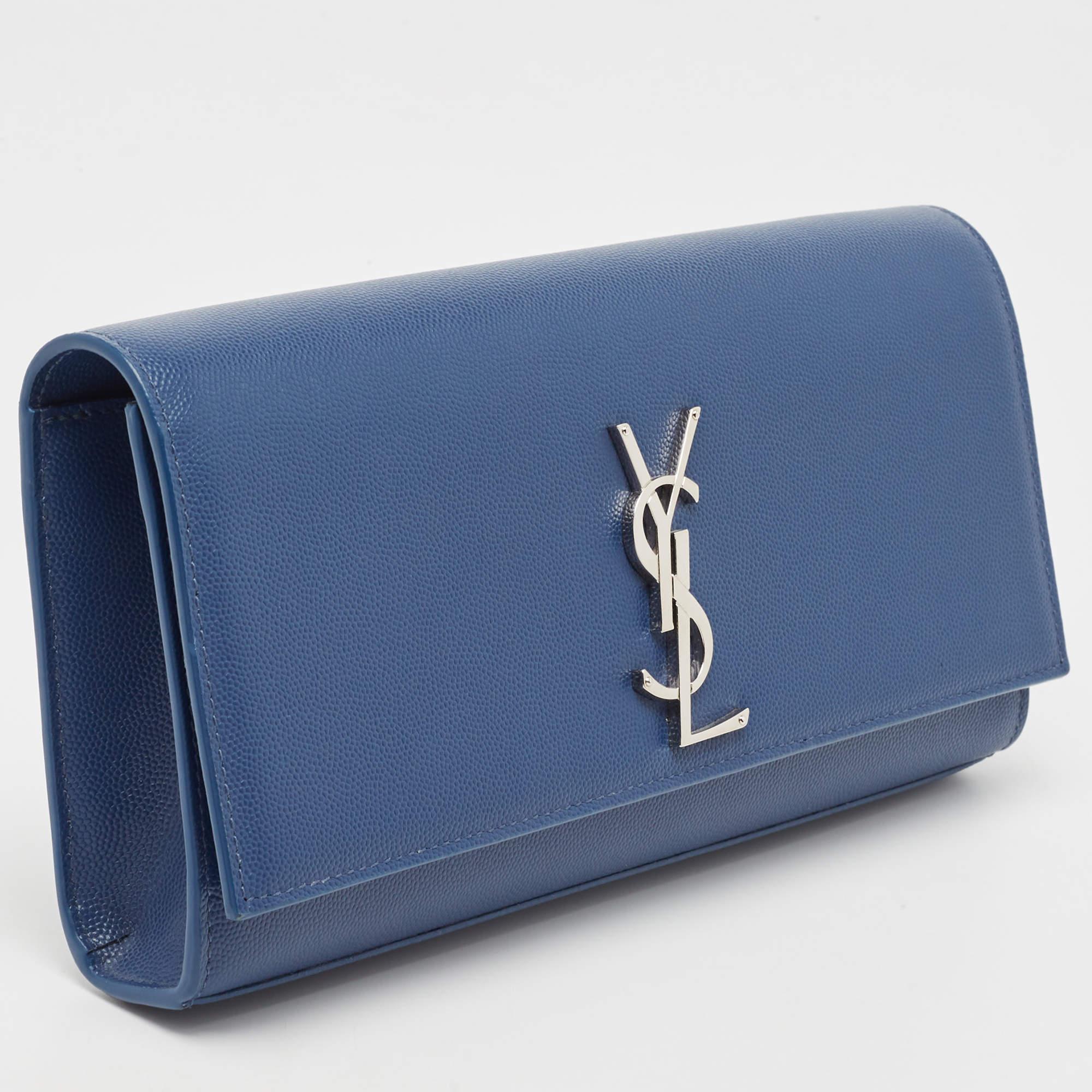 With a classic and chic style, this Saint Laurent Kate clutch will take a special place in your collection for years to come. Crafted in Italy, it is made from blue leather and has a lovely silhouette. The front flap is accented with silver-tone YSL