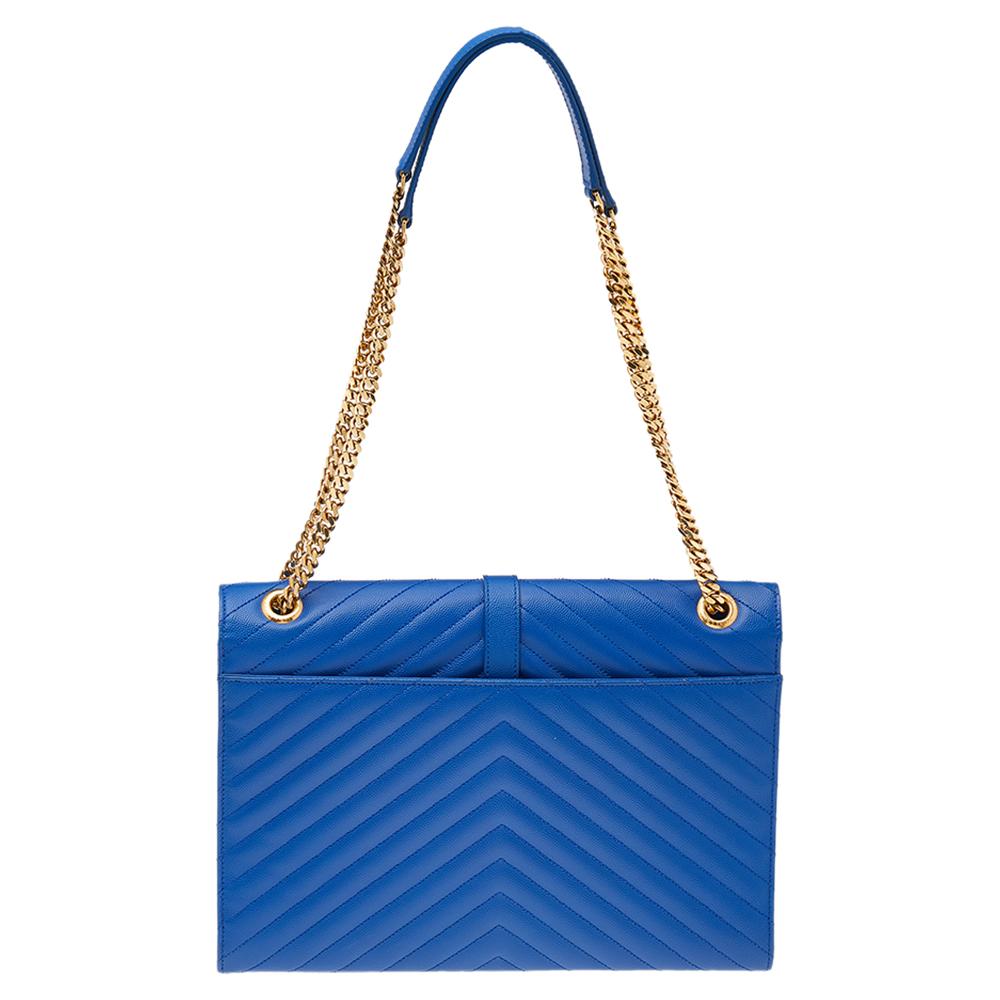 Fashioned using chevron-quilted leather into a structured silhouette, this blue Saint Laurent shoulder bag has high style and a timeless charm. It has a flap design and the front is highlighted with a gold-tone YSL logo. The interior is lined with