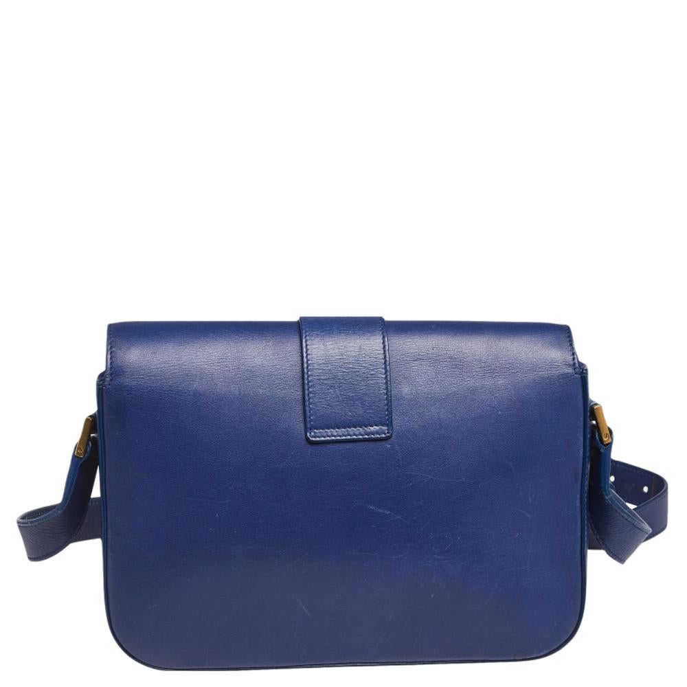 This blue Chyc Flap bag from Saint Laurent is ideal for everyday use. Crafted from leather, the bag is detailed with a gold-tone hardware Y motif snap closure and an adjustable shoulder strap. It opens to a spacious suede interior that is perfectly