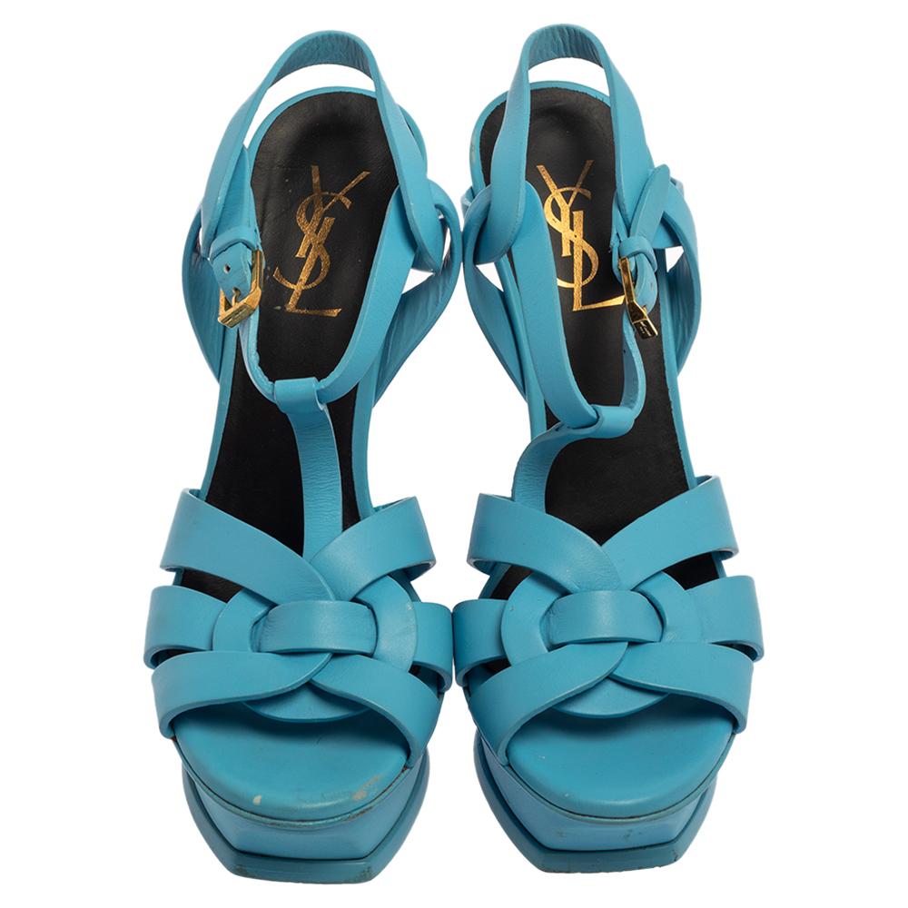 One of the most sought-after designs from Saint Laurent is their Tribute sandals. They are such a craze amongst fashionistas around the world, and it is time you own one yourself. These blue-hued ones are designed with glossy patent leather into a