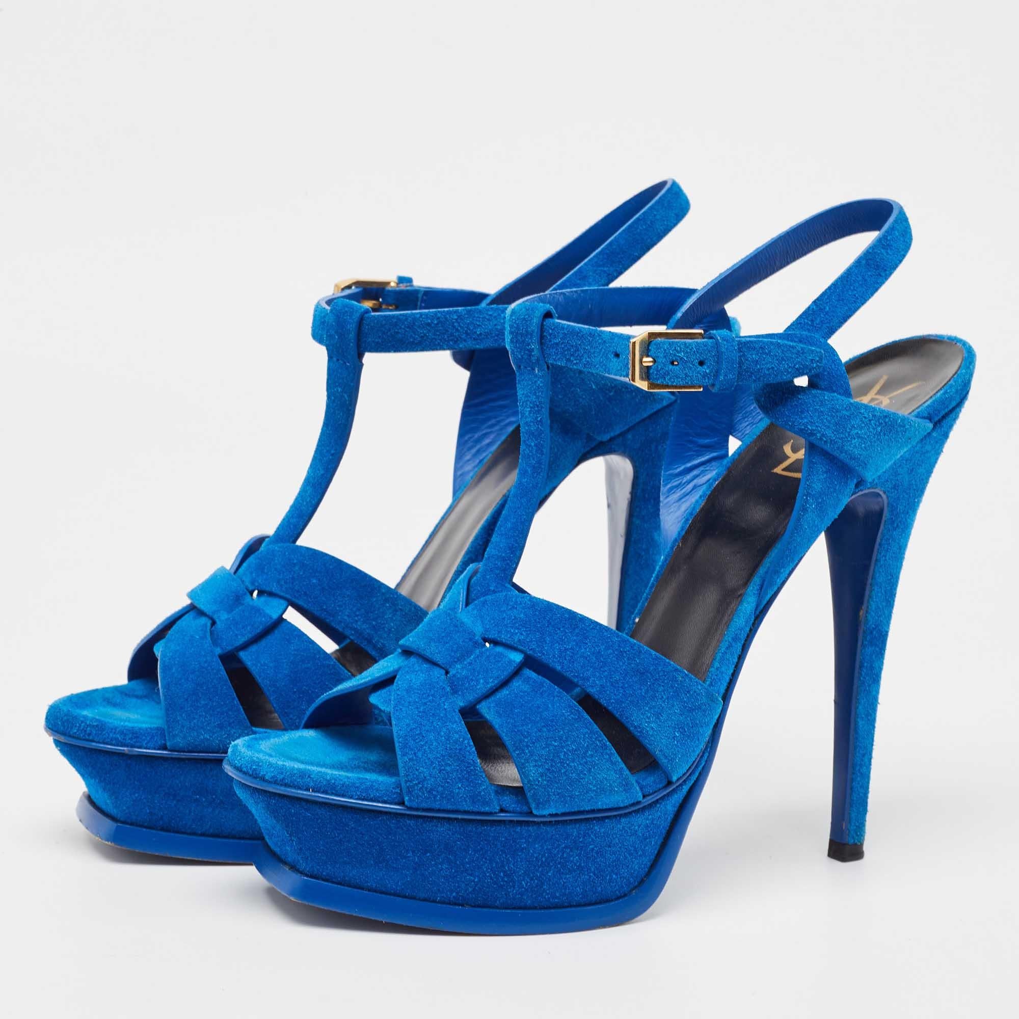 The fashionista in you will instantly fall in love with these Saint Laurent Tribute sandals They are made from suede with intertwined straps on the vamps and ankle buckle closure. The gold tone hardware 13.5cm heels and platforms give it a fine