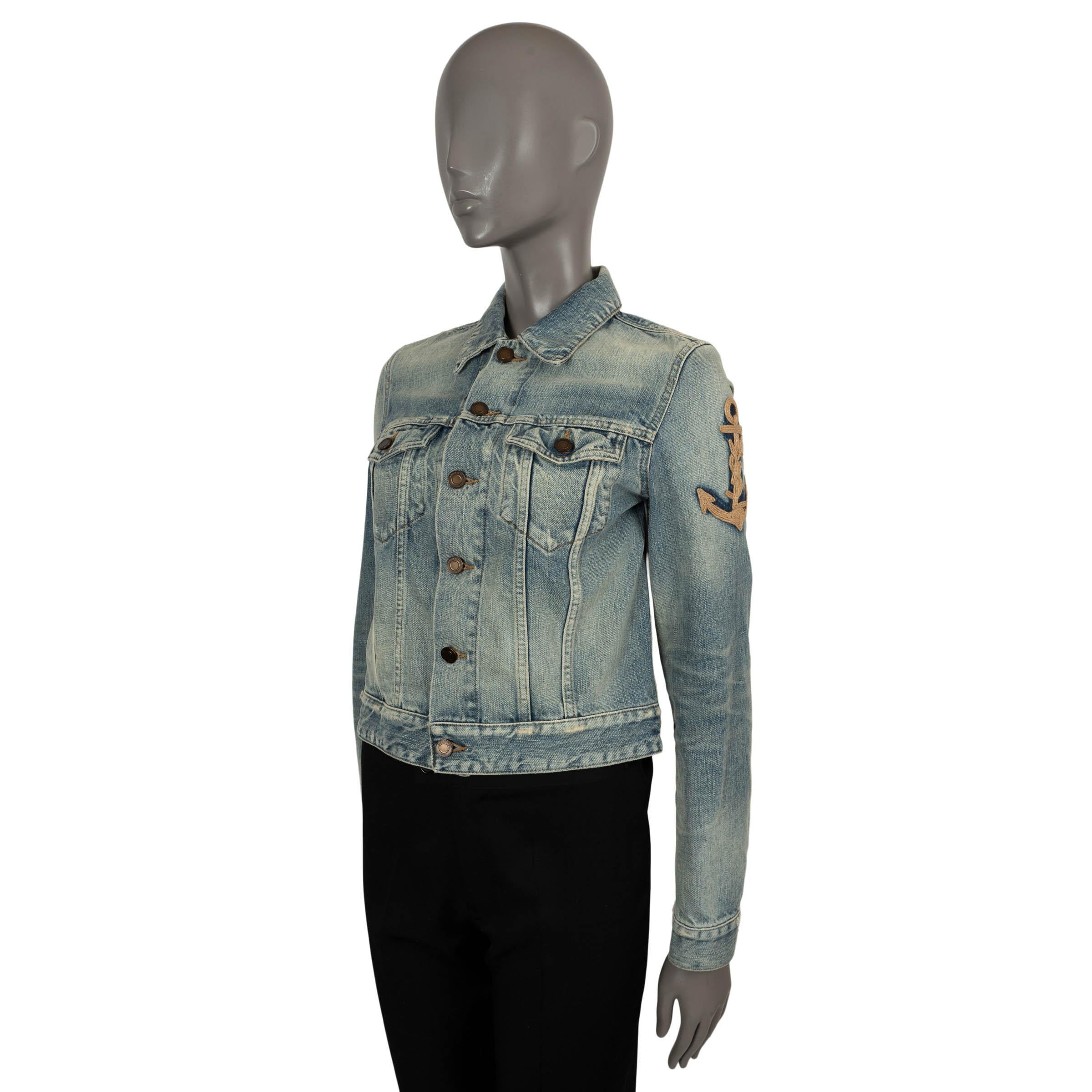 100% authentic Saint Laurent denim jacket in stone washed blue denim cotton (100%). Classic cut featuring distressed details, pointed collar, two flap pockets at the chest and an anchor embroidered on the sleeve in beige jute. Has been worn and is