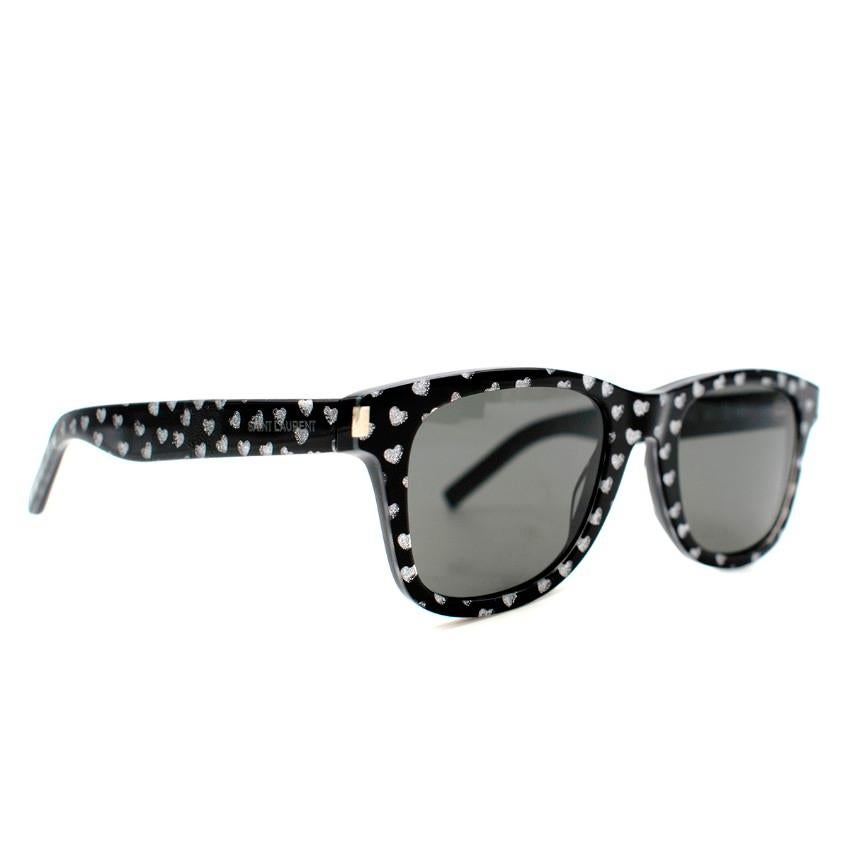 Saint Laurent Black Heart Print Round Sunglasses 

- Black Round Acetate Sunglasses 
- Silver Glittery Heart Prints all over 
- Logo imprint on sides 
- This item comes with an original case. 

Please note, these items are pre-owned and may show
