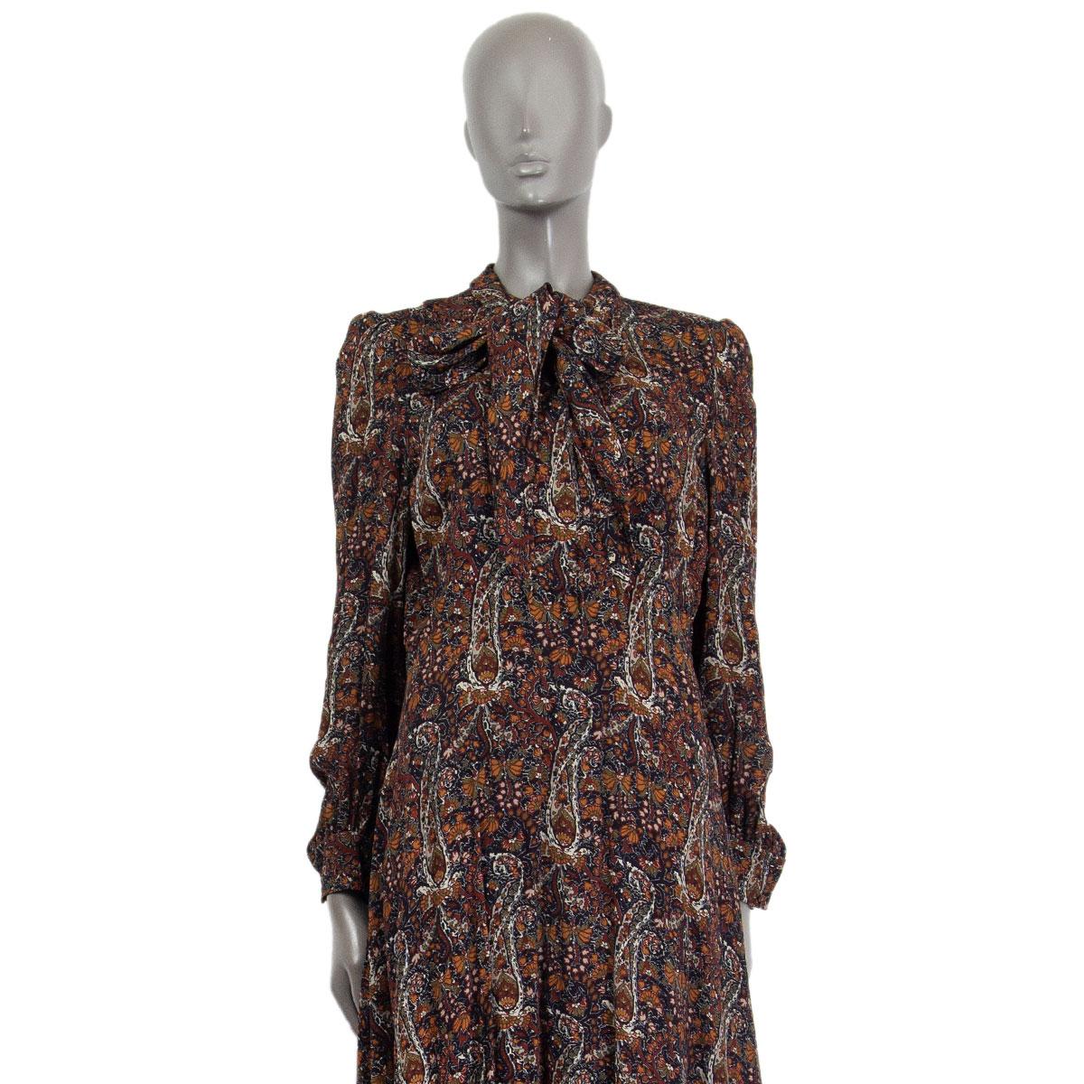 Saint Laurent lavallière-neck midi dress in multi-color viscose (100%) with a handkerchief hem, long sleeves and buttoned cuffs. Closes on the front with buttons and fastens on the side with a concealed zipper. Lined in silk (100%). Has been worn