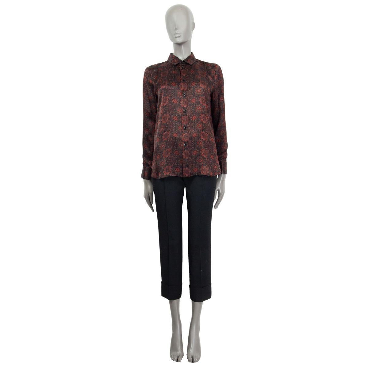 100% authentic Saint Laurent geometric flower-print like blouse in black, brown, orange, red and sage silk (100%) with a classic collar, long sleeves and a rounded hemline. Closes with button fastening in the front. Has been worn and is in excellent