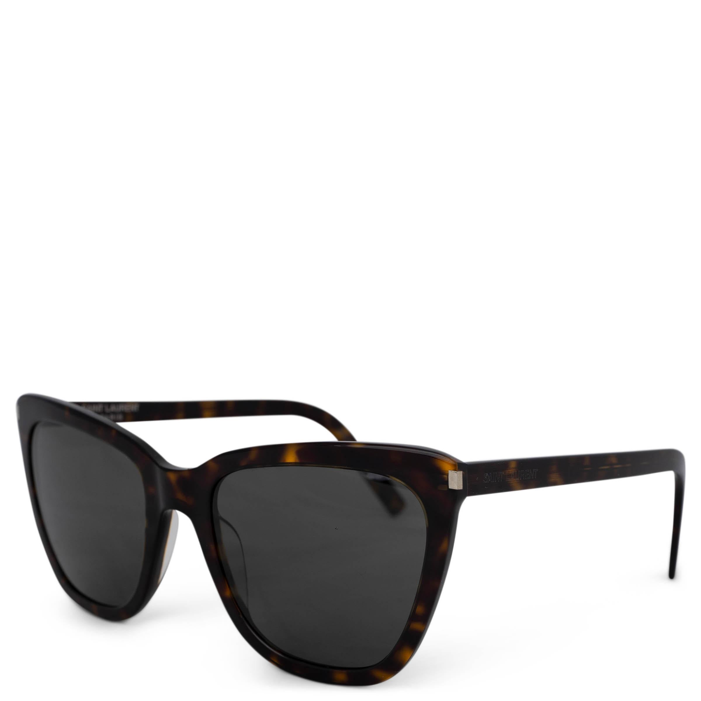 These 100% authentic Saint Laurent Classic SL 548 Slim sunglasses are crafted from dark brown and amber tortoise acetate, featuring sleek grey lenses. With a timeless and refined design, these sunglasses offer both style and UV protection, making