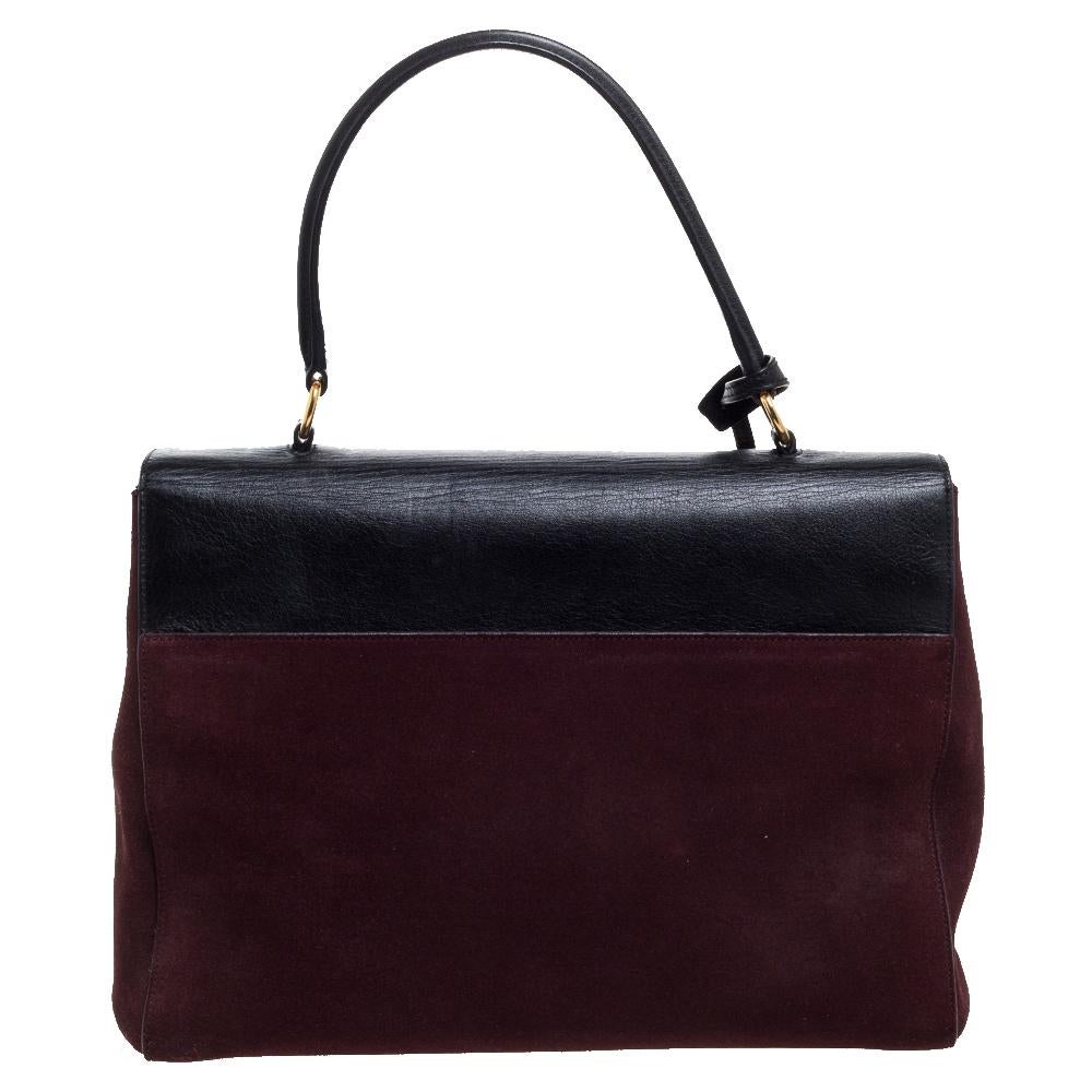 This stunning bag from Saint Laurent is a must-have, Crafted from suede, it comes in a burgundy color and delivers sophistication in spades. It can be carried by its top handle or the detachable shoulder strap. The exterior features a gold-stamped