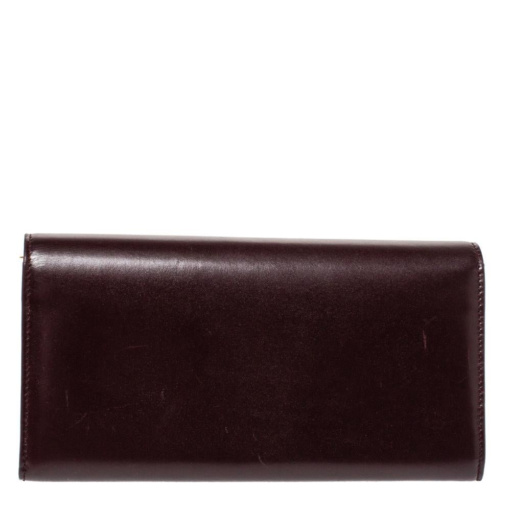 A suave creation from the house of Saint Laurent. Featuring a leather exterior, this wallet is a convenient accessory with a zip pocket, multiple card slots and a full flap with snap-button closure. The rich burgundy hue of this stylish wallet with
