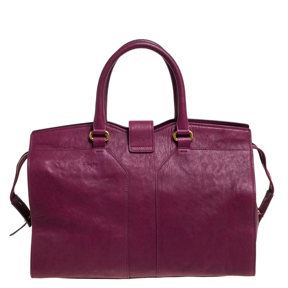 This elegant burgundy Cabas Chyc tote from Saint Laurent is ideal for everyday use. Crafted from leather, the bag is detailed with a gold-tone Y motif snap closure and dual-rolled handles. The top zip closure opens to a spacious interior that is