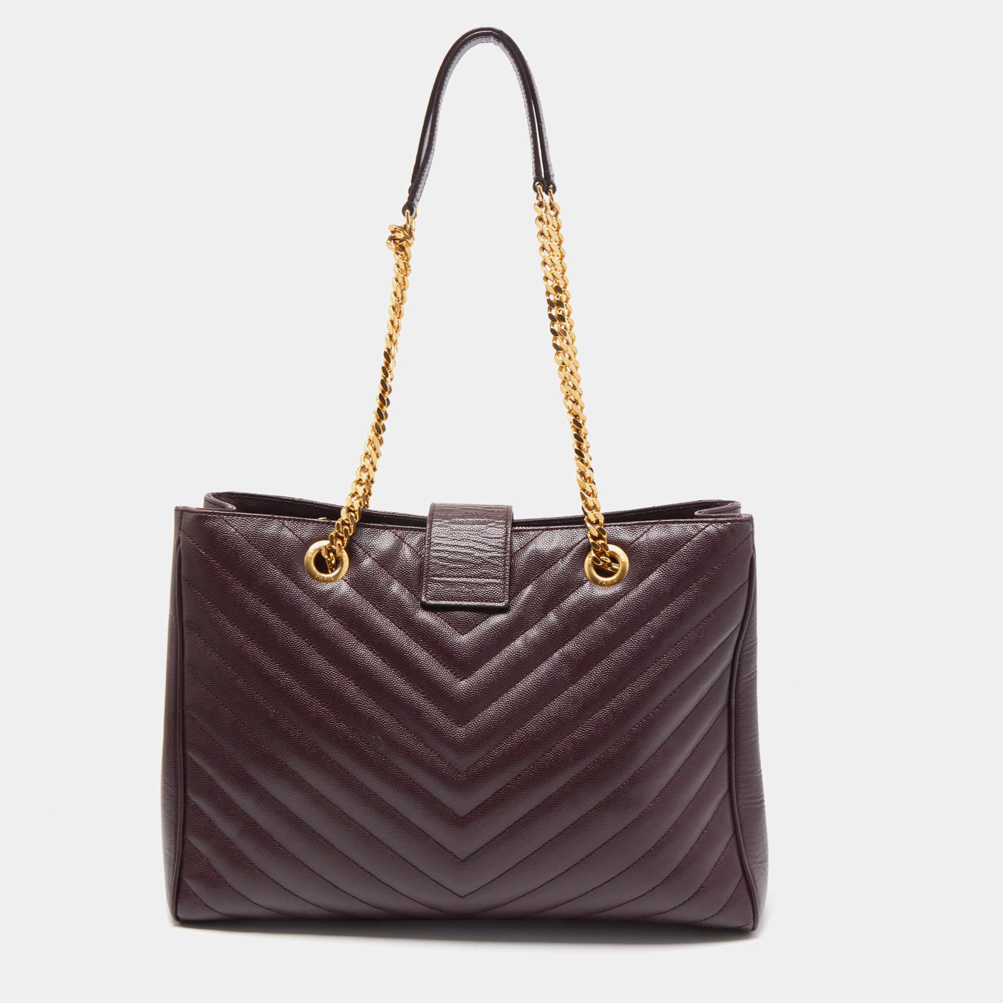 This Saint Laurent bag is stunning, with chevron lines and an elegant design. The bag has chain handles and a YSL logo in gold-tone metal. The fabric interior is divided by a zip compartment and will easily hold your essentials.
 
Includes: Original