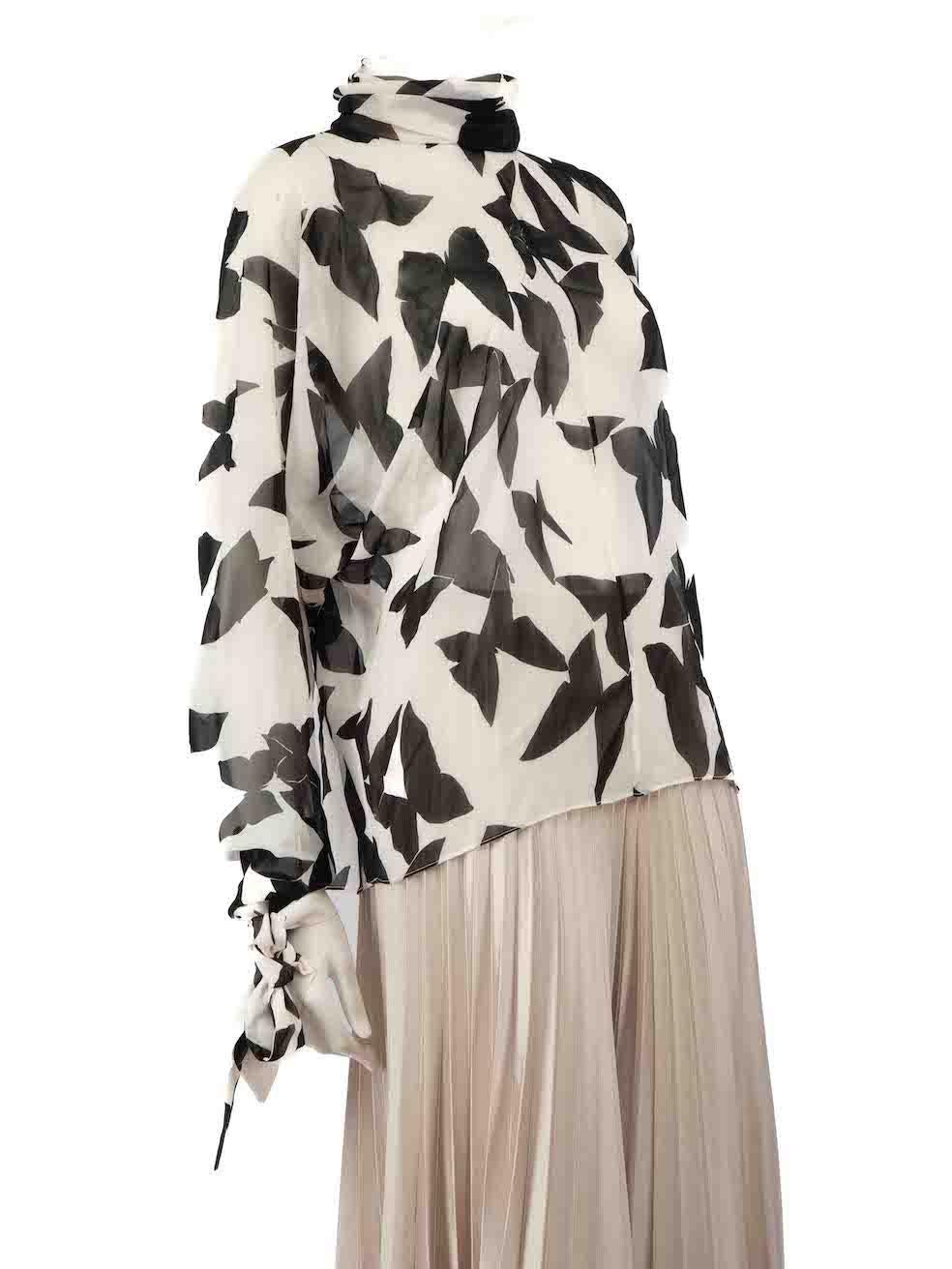 CONDITION is Very good. Hardly any visible wear to blouse is evident on this used Saint Laurent designer resale item.
 
 
 
 Details
 
 
 White
 
 Silk
 
 Blouse
 
 Black butterfly pattern
 
 Long sleeves
 
 Tie cuffs
 
 Sheer
 
 Mock neck
 
 Back
