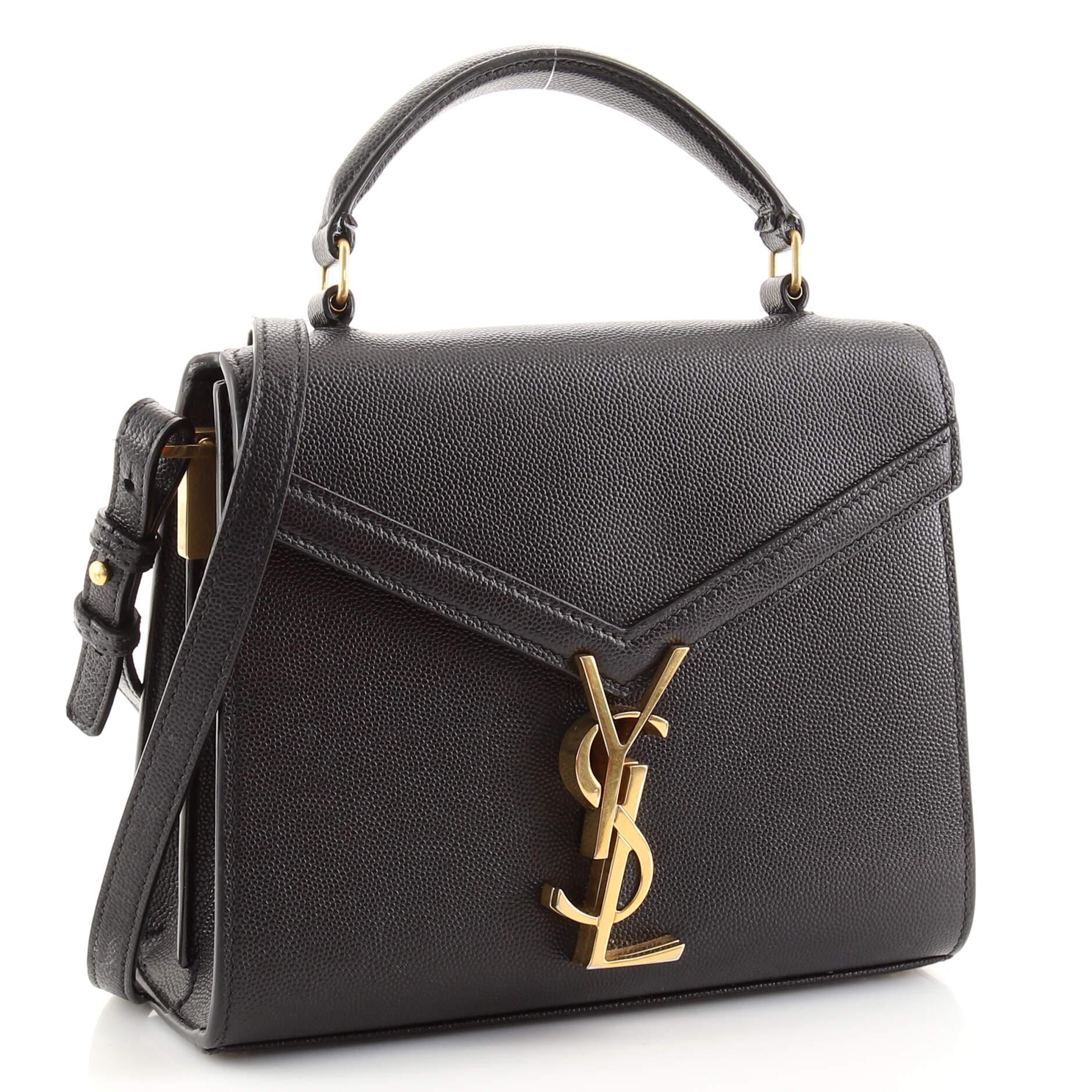 Condition: Good. Odor in interior. Moderate wear, marks and scuffs on exterior, handle, strap and in interior, stickiness on handle and strap. Fraying and splitting on handle base and flap opening wax edges, tarnish, discoloration and scratches on