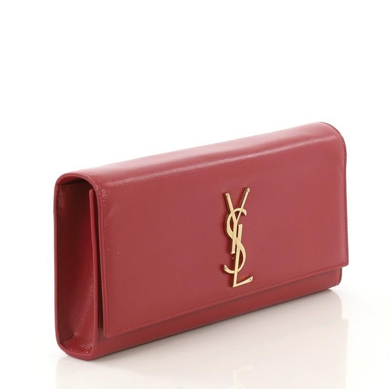 This Saint Laurent Classic Monogram Clutch Leather Long, crafted in red leather, features YSL logo at the front and gold-tone hardware. Its magnetic snap closure opens to a red suede interior with slip pocket.

Estimated Retail Price: