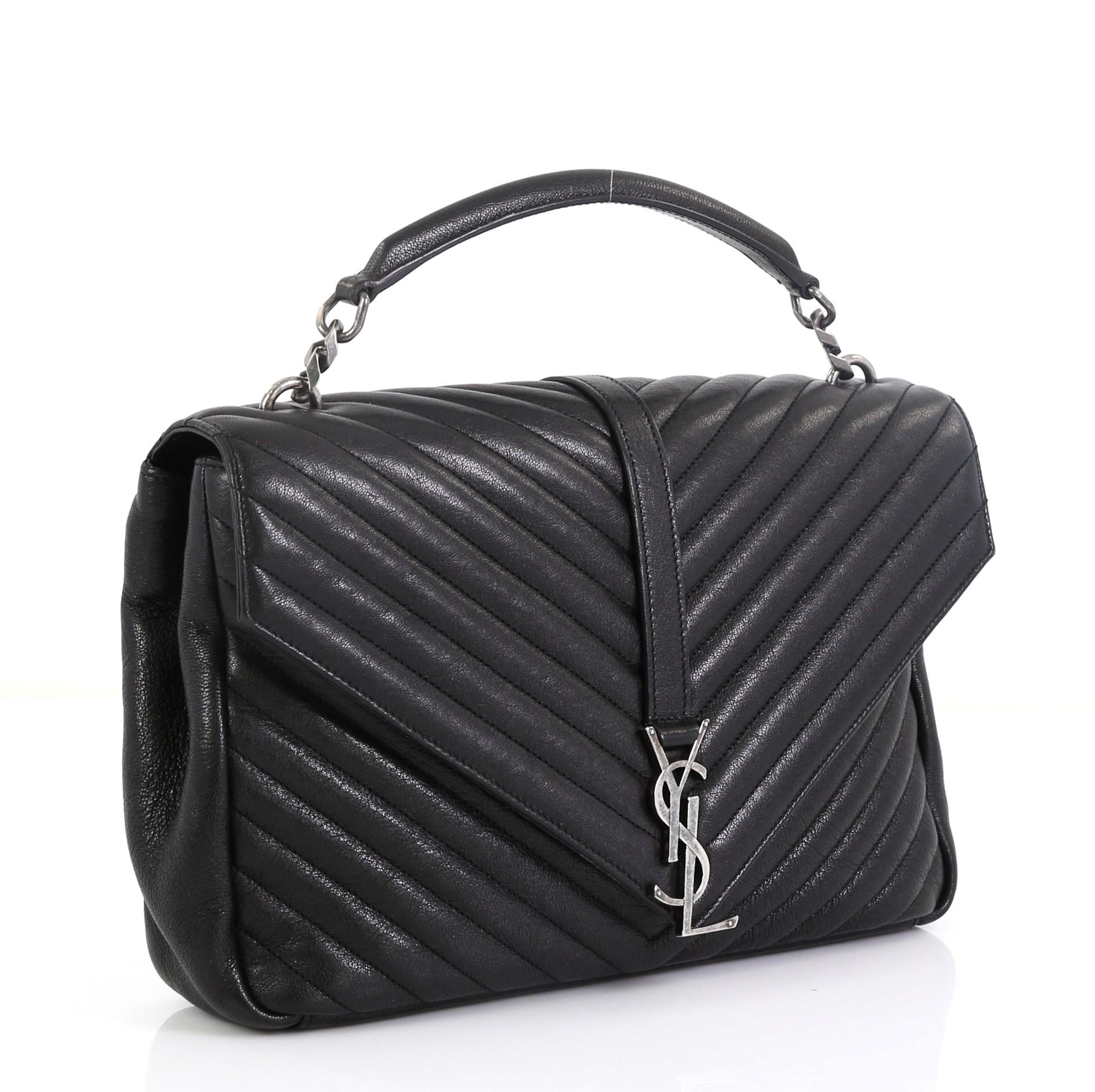 This Saint Laurent Classic Monogram College Bag Matelasse Chevron Leather Large, crafted in black matelasse chevron leather, features a single top handle, exterior back pocket, and aged silver-tone hardware. Its magnetic snap closure opens to a