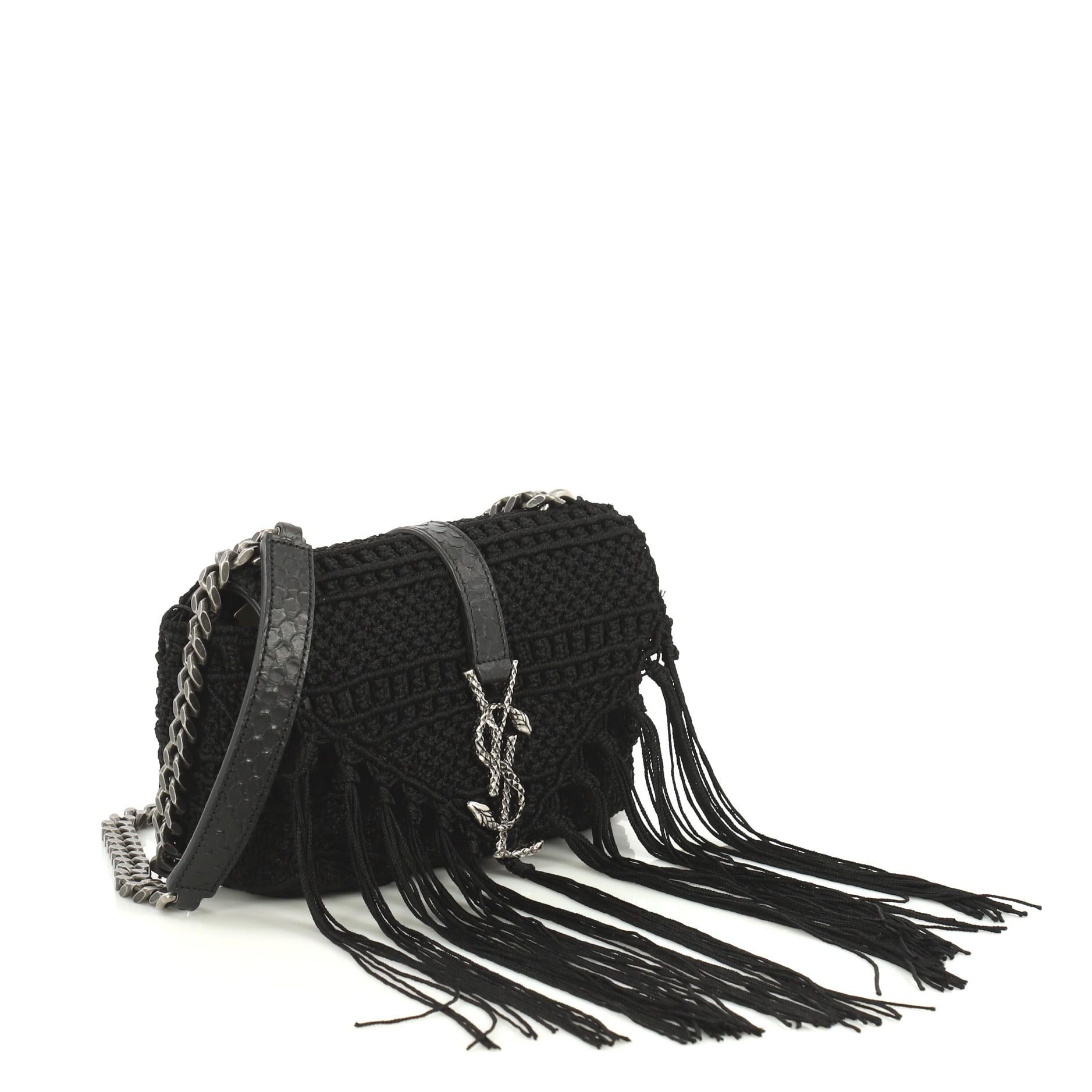 This Saint Laurent Classic Monogram Crossbody Bag Crochet Over Leather Baby, crafted from black crochet over leather, features chain link strap with leather shoulder pad, cascading fabric fringes and aged silver-tone hardware. Its hidden magnetic