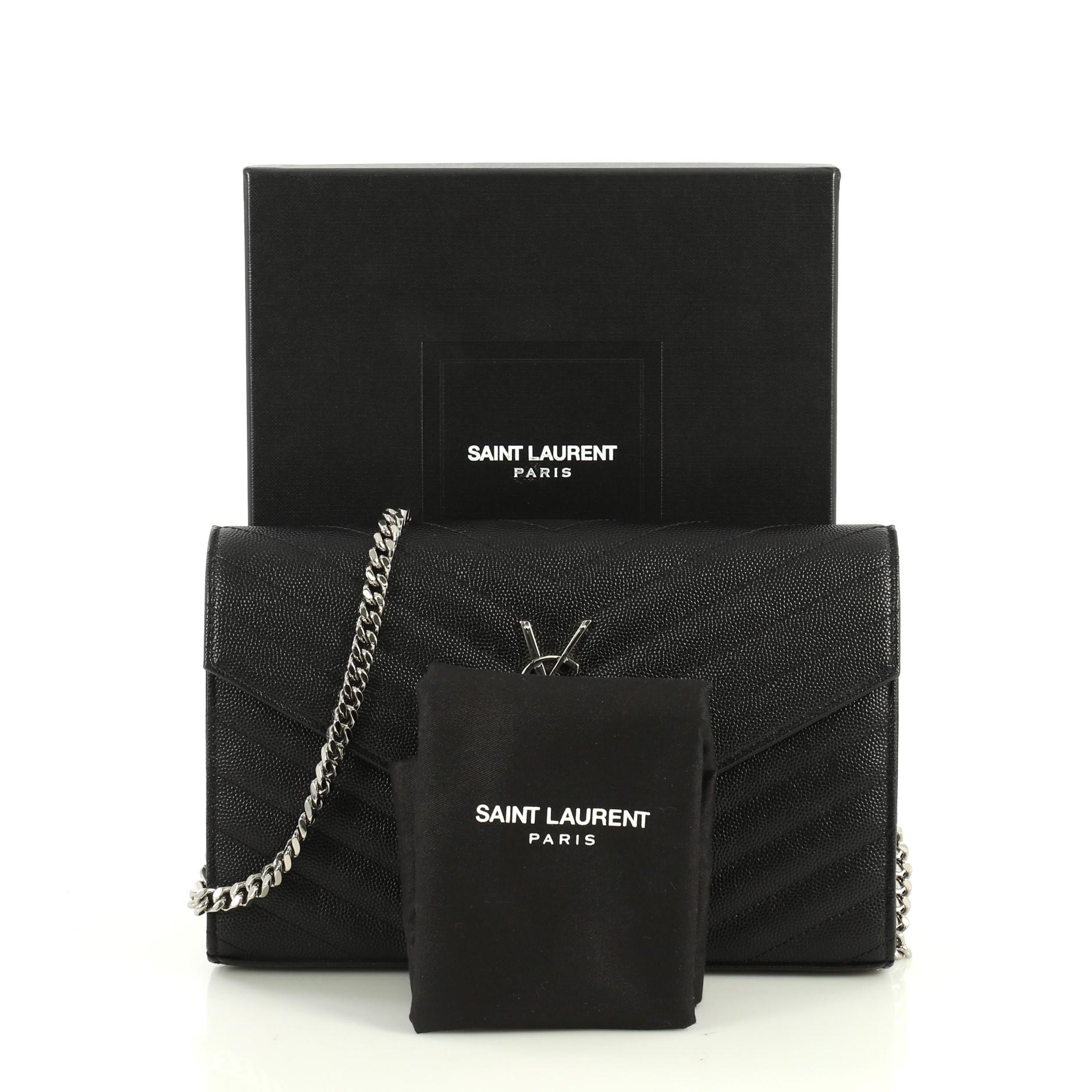 This Saint Laurent Classic Monogram Wallet on Chain Matelasse Chevron Leather Medium, crafted from black matelasse chevron leather, features chain link strap, YSL monogram logo at the front, and silver-tone hardware. Its magnetic snap closure opens