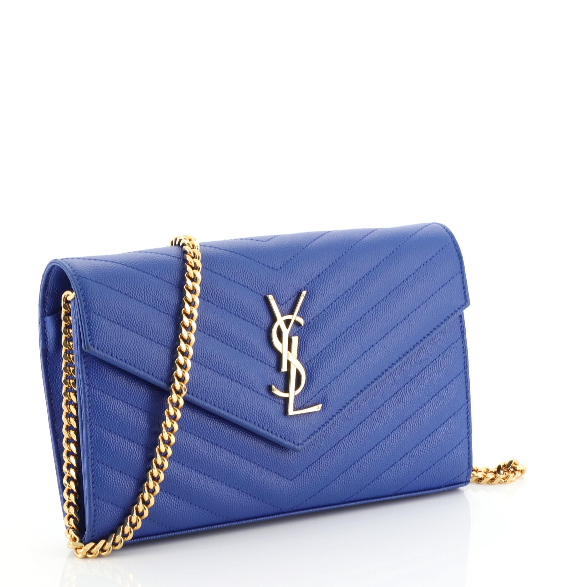 This Saint Laurent Classic Monogram Wallet on Chain Matelasse Chevron Leather Medium, crafted from blue matelasse chevron leather, features chain link strap, YSL monogram logo at the front, and gold-tone hardware. Its snap closure opens to a black