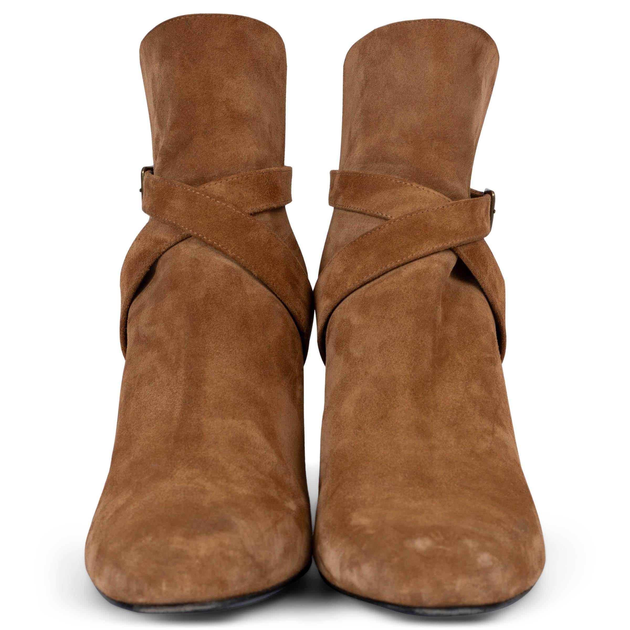 These 100% authentic Saint Laurent Babies 90 ankle boots in cognac brown suede are a chic addition to any wardrobe. They feature crisscross ankle straps with a small side buckle, almond toes, and suede-covered block heels adorned with the iconic YSL