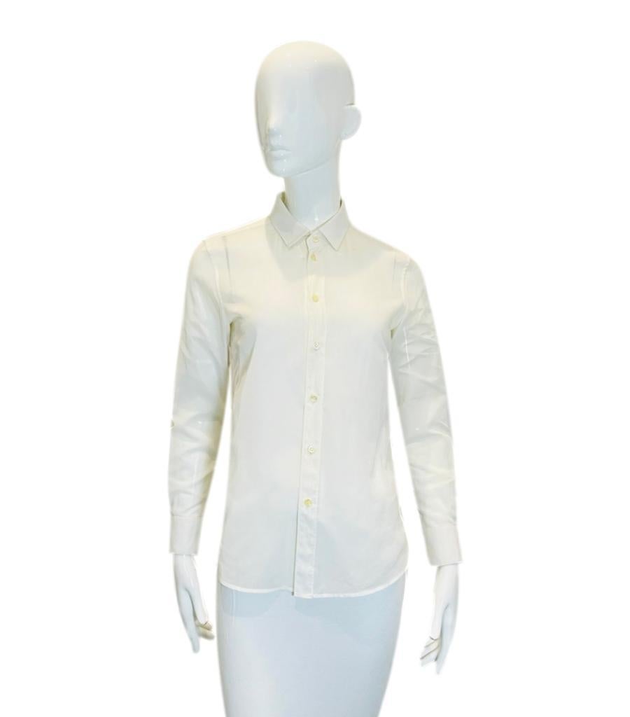 Saint Laurent Cotton Shirt

Classic off-white shirt designed with a pointed collar and centre button closure.

Featuring buttoned cuffs and straight-cut silhouette.

Size – 36FR

Condition – Fair/Good (Some stains and marks)

Composition – 100%