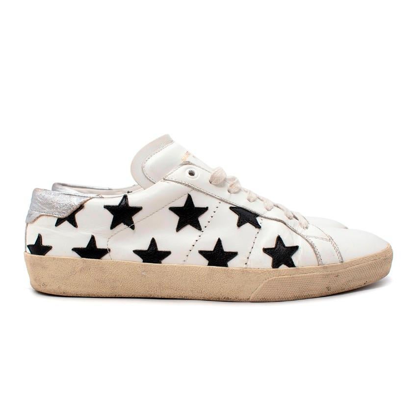  Saint Laurent Court Classic White Leather Star Applique Sneakers
 

 - Smooth white leather sneakers embellished in black-leather star applique
 - Metallic silver heel panel 
 - Tonal lace-up closure
 - Gold foil logo on to tongue
 

 Materials:
