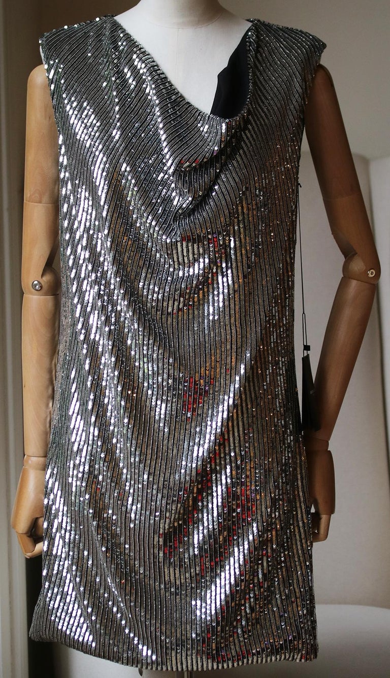 Evoke Saint Laurent's 1980s party spirit with this shimmering cowl-neck dress. It's crafted from rows of silver sequins on a black silk base, and is designed to drape softly over the body for a slinky, fluid feel. Wear it with classic accessories –