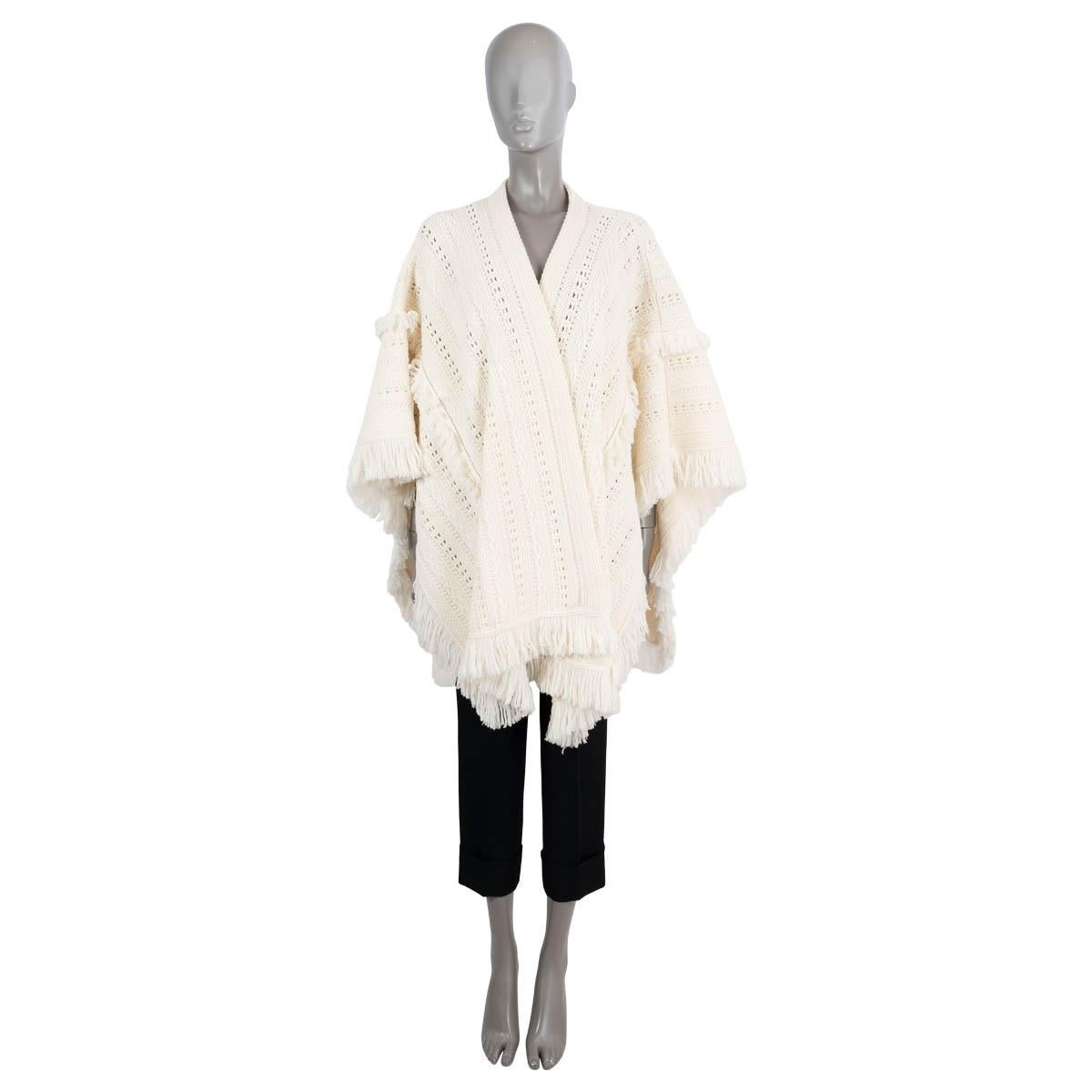 100% authentic Saint Laurent crochet knit poncho in cream wool (100%). Features a loose fit with tactile fringe trims giving nods to North-African influences. Open front and is unlined. Has been worn and is in excellent condition.

Resort