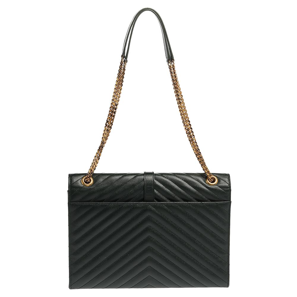 Elevate your fashionable outfits with this Envelope shoulder bag by Saint Laurent. It is crafted from leather in dark green and features a chevron-quilted pattern throughout and the YSL logo in gold-tone on the front flap. The flap opens to reveal a