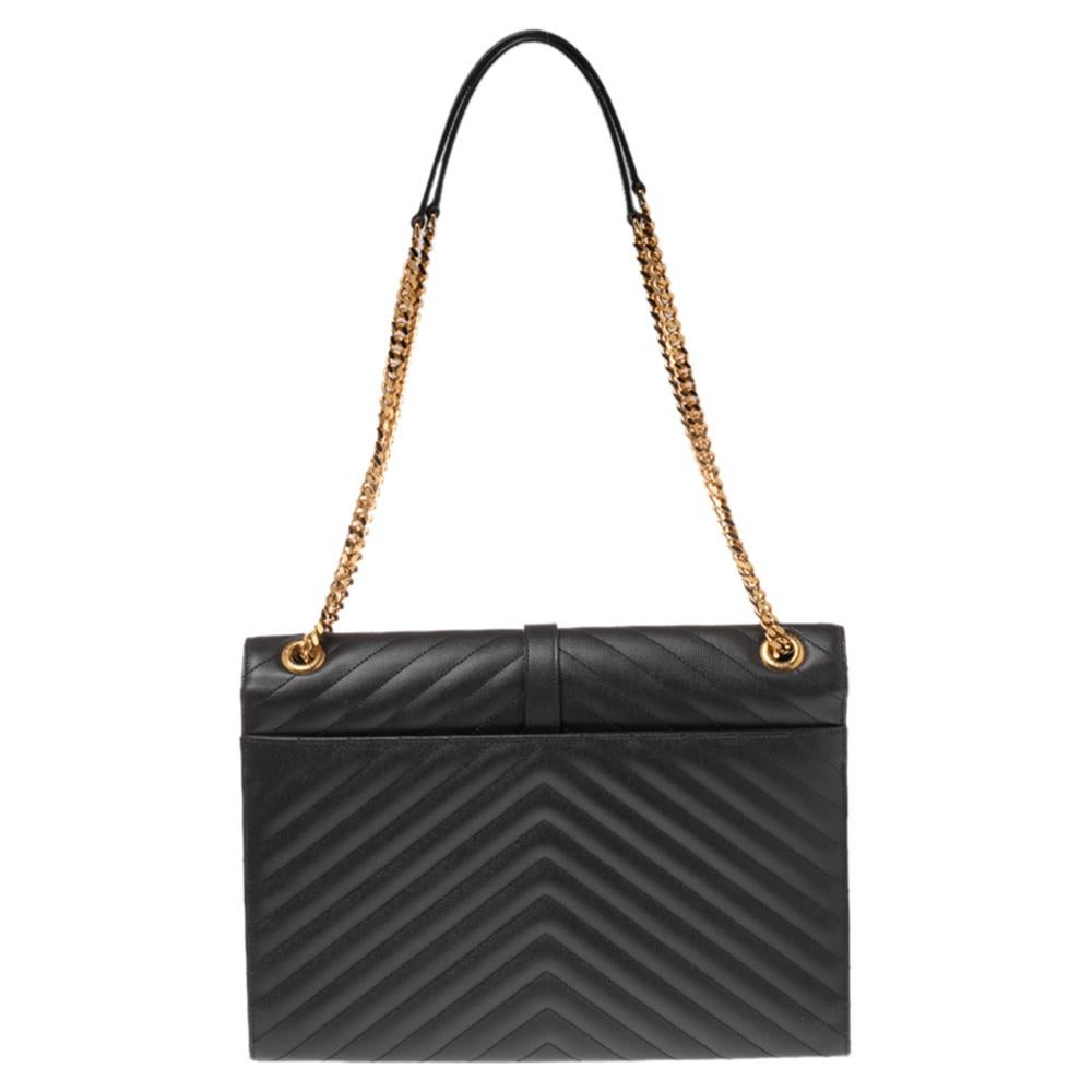 Fashioned using quilted Matelassé leather into a smart silhouette, this Saint Laurent Monogram Envelope bag has high style and a timeless charm. It has a flap design and the front is highlighted with a gold-tone YSL logo for a signature finish.

