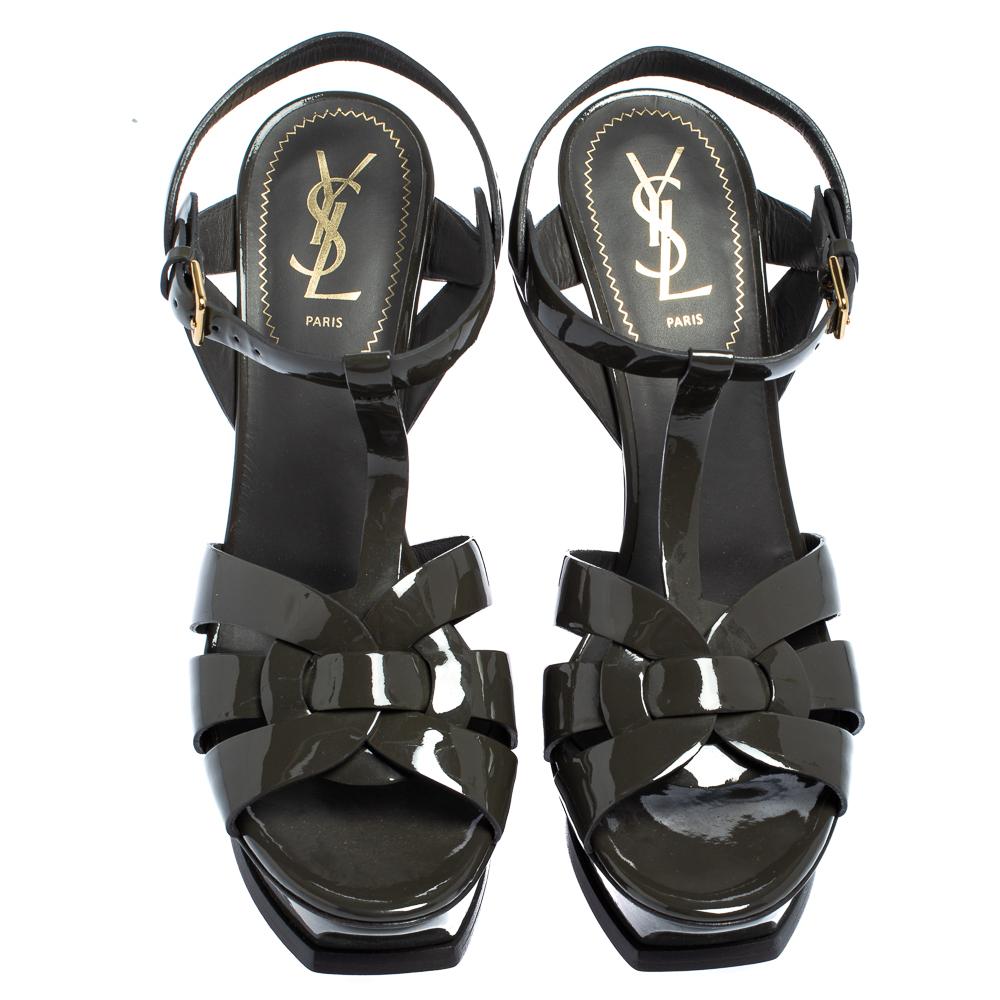 One of the most sought-after designs from Saint Laurent is their Tribute sandals. They are such a craze amongst fashionistas around the world, and it is time you own one yourself. These dark grey ones are designed with patent leather straps, ankle