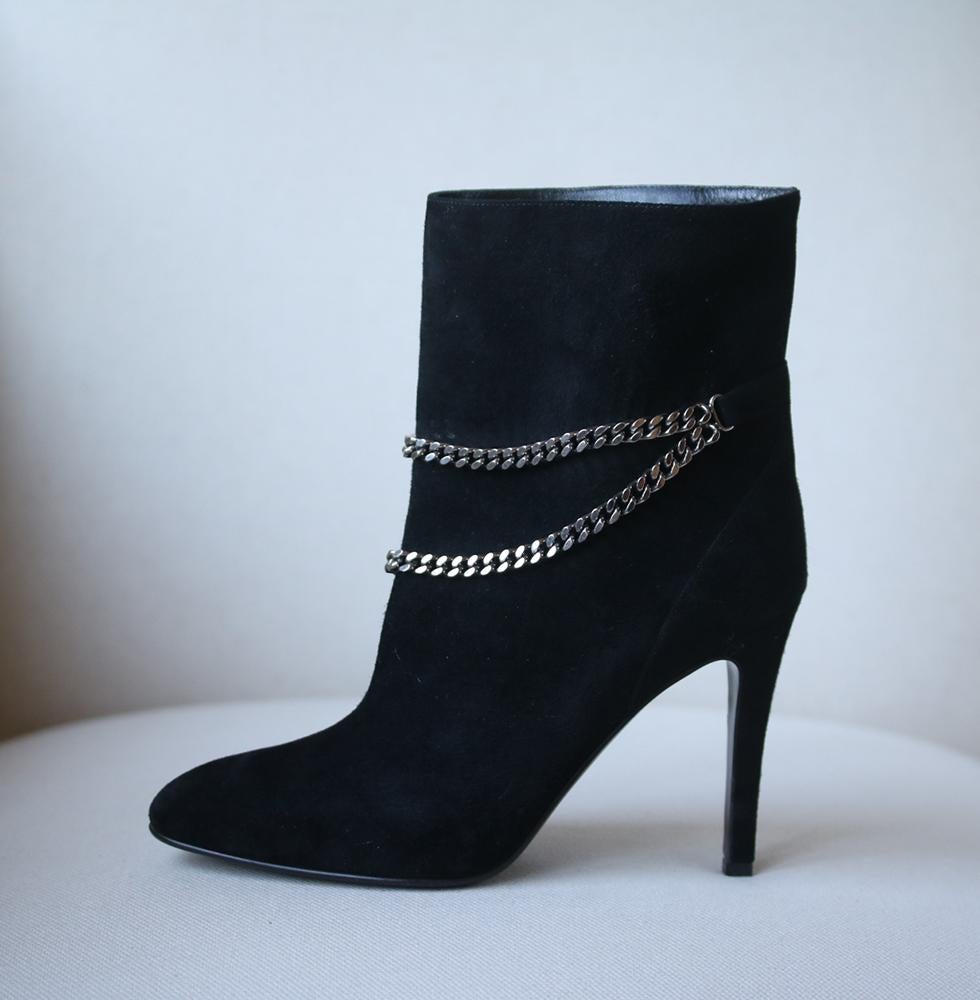 Saint Laurent's perfect suede boots boast a slim heel and a flattering slanted double chain around the ankle. Heel measures approximately 100mm/ 4 inches with a 10mm/ 0.5 inch platform. Black suede. Almond toe. Pull on. Does not come with a box.