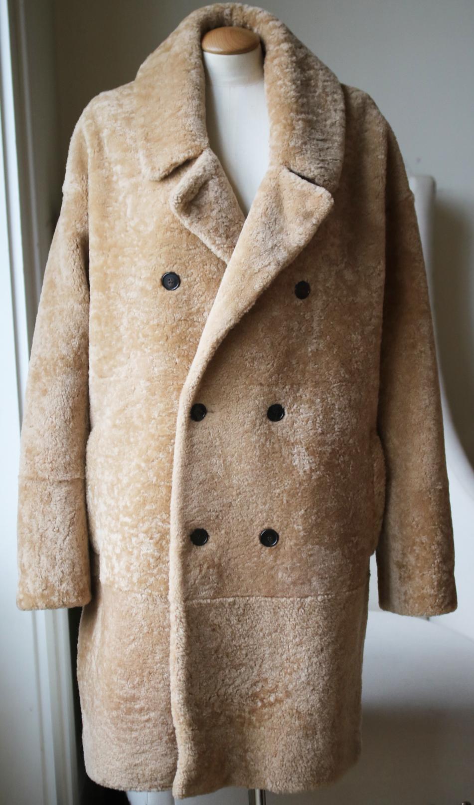 Saint laurent's coat is cut from plush shearling for the cosiest feel and designed with a smart double-breasted front. Lined in satin for a faultless drape. It's shaped with notch lapels. Two slip pockets. Logo-etched horn buttons. Honey-tone