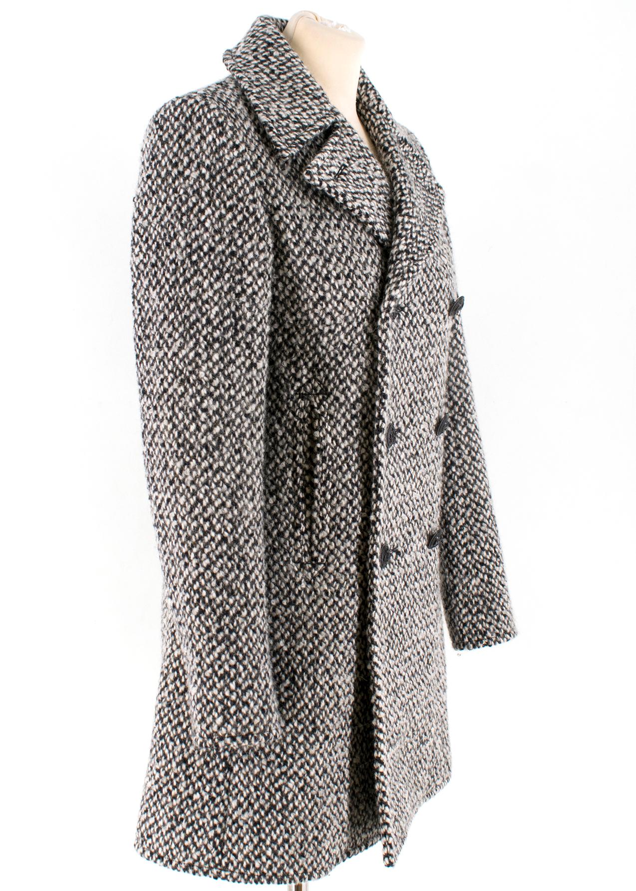 Saint Laurent double breasted tweed coat

- Black and white wool-blend tweed
- Notch lapels, long sleeves
- Off-centre front button fastening
- Silk linings with one pocket
- Made in Italy

Please note, these items are pre-owned and may show some