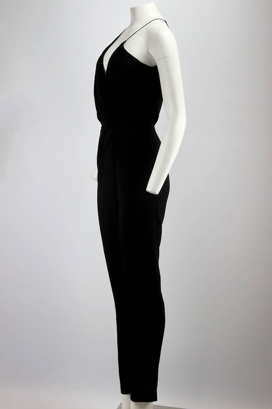 This jumpsuit by Saint Laurent is sleek, elegant and comfortable, made from woven fabric with as plunging asymmetric neckline with draped detail around to waist, which falls to straight legs. Black viscose. Hook, eye and zip fastening at front. 100%