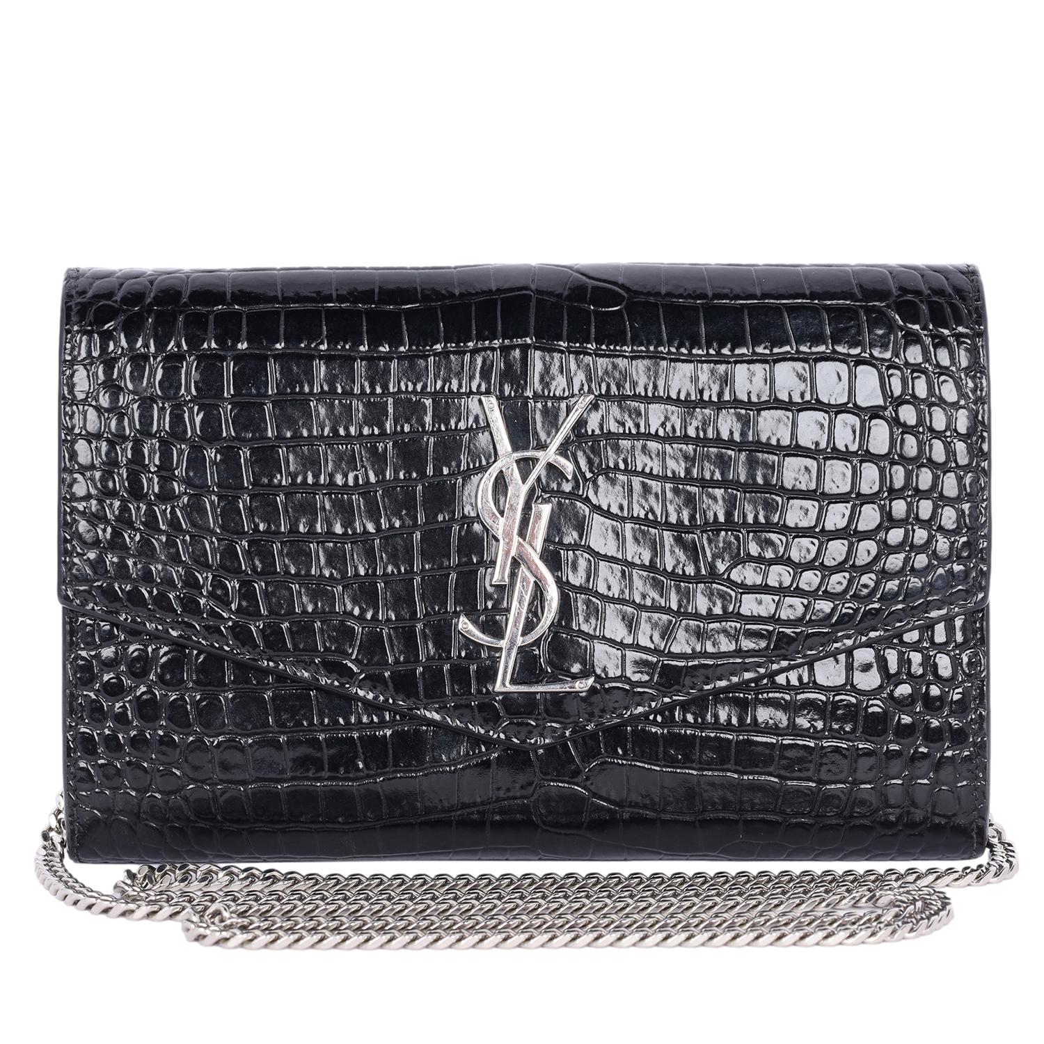 Authentic, pre-owned Saint Laurent YSL embossed uptown Wallet on a Chain in black. This classic bag is one that will take you through all seasons. Adorned with iconic 'YSL' silver hardware, embossed leather and has a sleek envelope shape front flap,