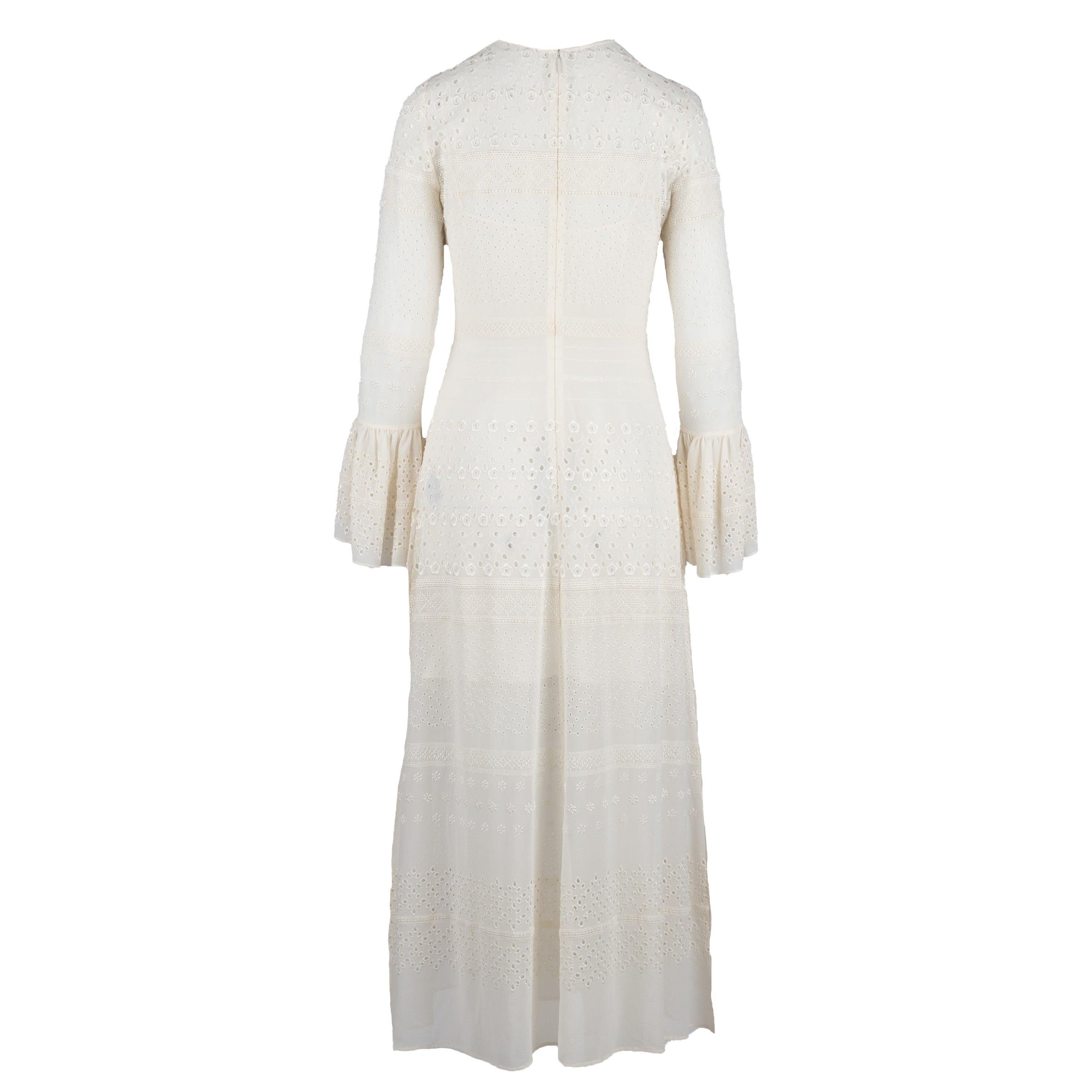 This Saint Laurent Embroidered Long Dress is the perfect summer piece. Crafted with a semi-sheer maxi dress made from white silk blend fabric and adorned with perforated cotton floral embroidery, it also comes with an interior silk slip dress and a