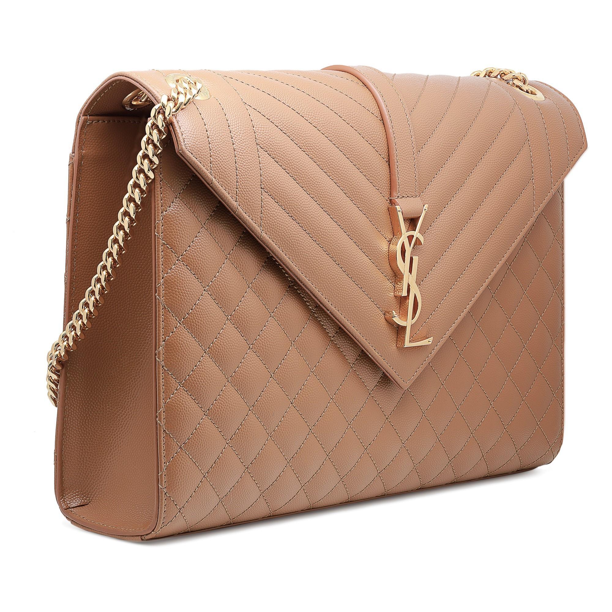 Saint Laurent Envelope large quilted leather crossbody bag. Featuring diamond quilting at the front and back with mixed stripe quilting at the front flap. Strap and logo hardware detail at front flap. Gold-tone hardware. Magnetic flap closure.