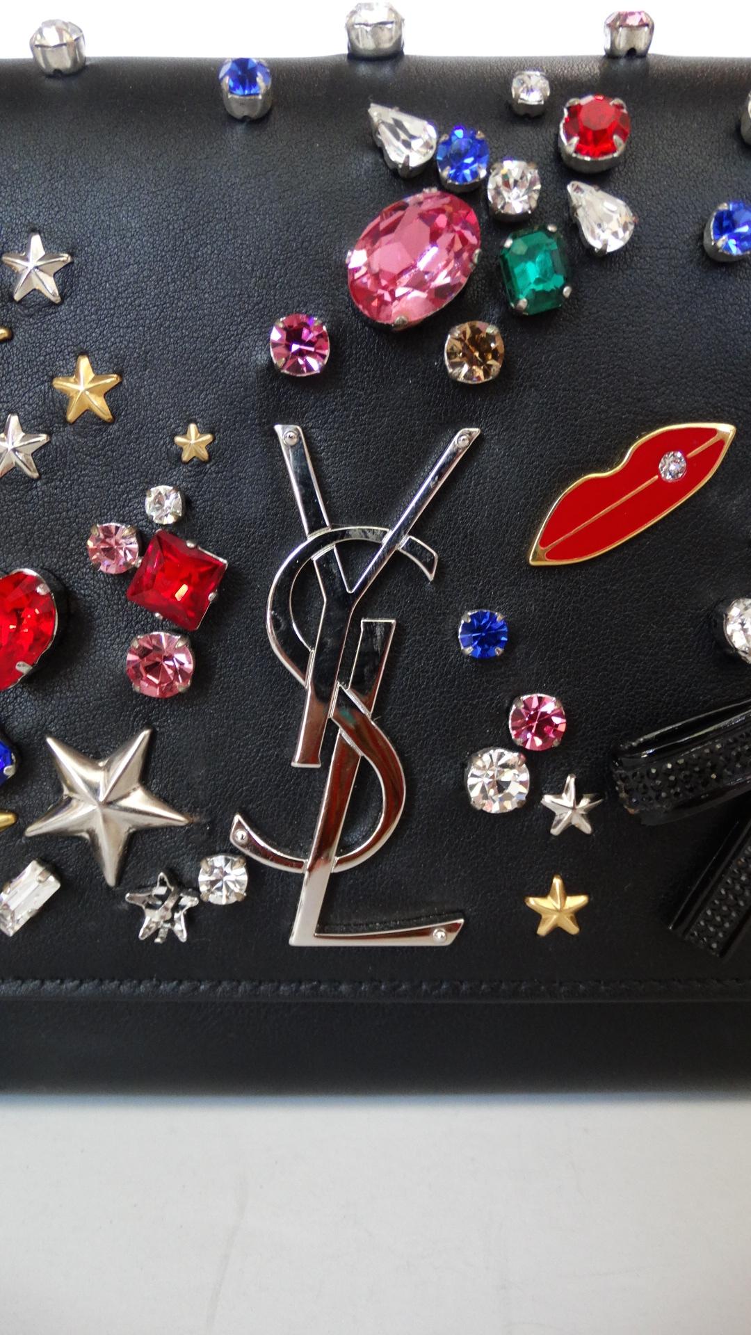 The most magical embellished bag from Saint Laurent's Fall/Winter 2016 collection! Made of a soft black leather and decorated all over with rhinestones, bows, stars, moons, lips and music notes! 