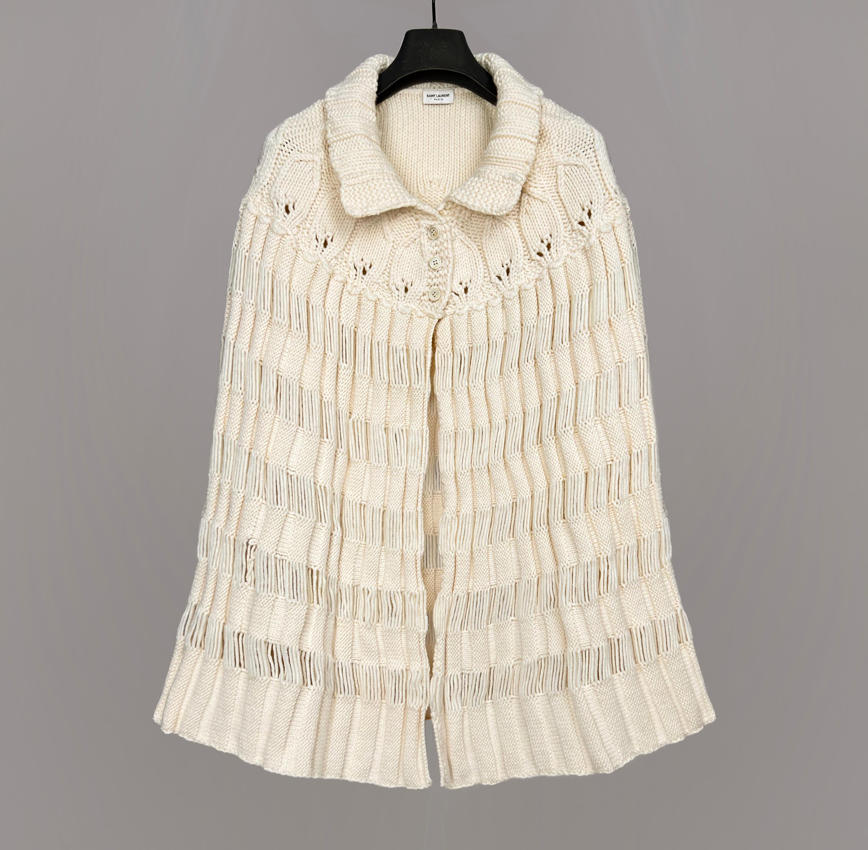 

Saint Laurent Pre-Owned F/W 2015 by Hedi Slimane chunky knit crochet poncho
Made in Italy
Highlights
	ivory white
	wool
	chunky knit
	crochet knit
	classic collar
	front button fastening
	straight hem
size M (one size fit)
	made in