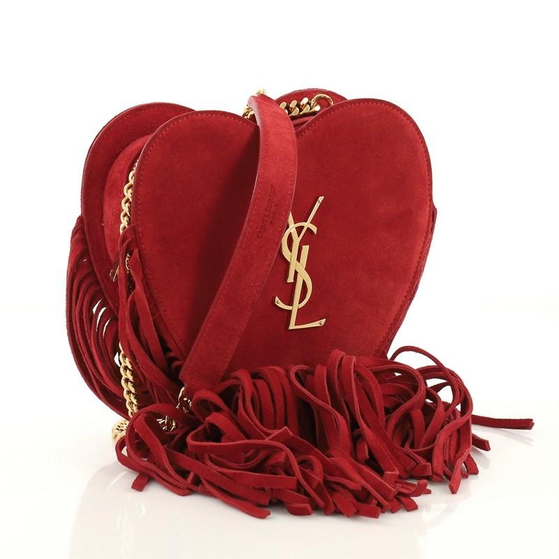 This Saint Laurent Fringe Love Heart Chain Bag Suede Small, crafted from red suede, features chain link strap, signature interlocking YSL logo, cascading suede fringe and gold-tone hardware. Its all-around zip closure opens to a red suede interior.