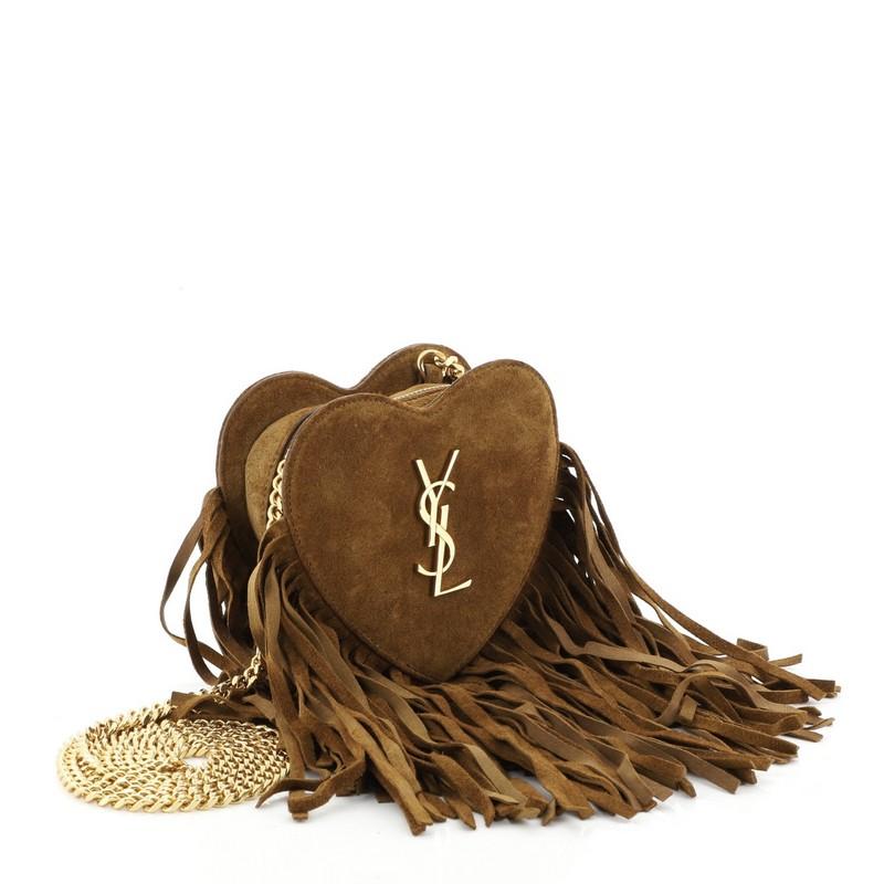 This Saint Laurent Fringe Love Heart Chain Bag Suede Small, crafted from brown suede, features chain link strap, interlocking YSL logo, cascading suede fringe and gold-tone hardware. Its all-around zip closure opens to a black leather interior.