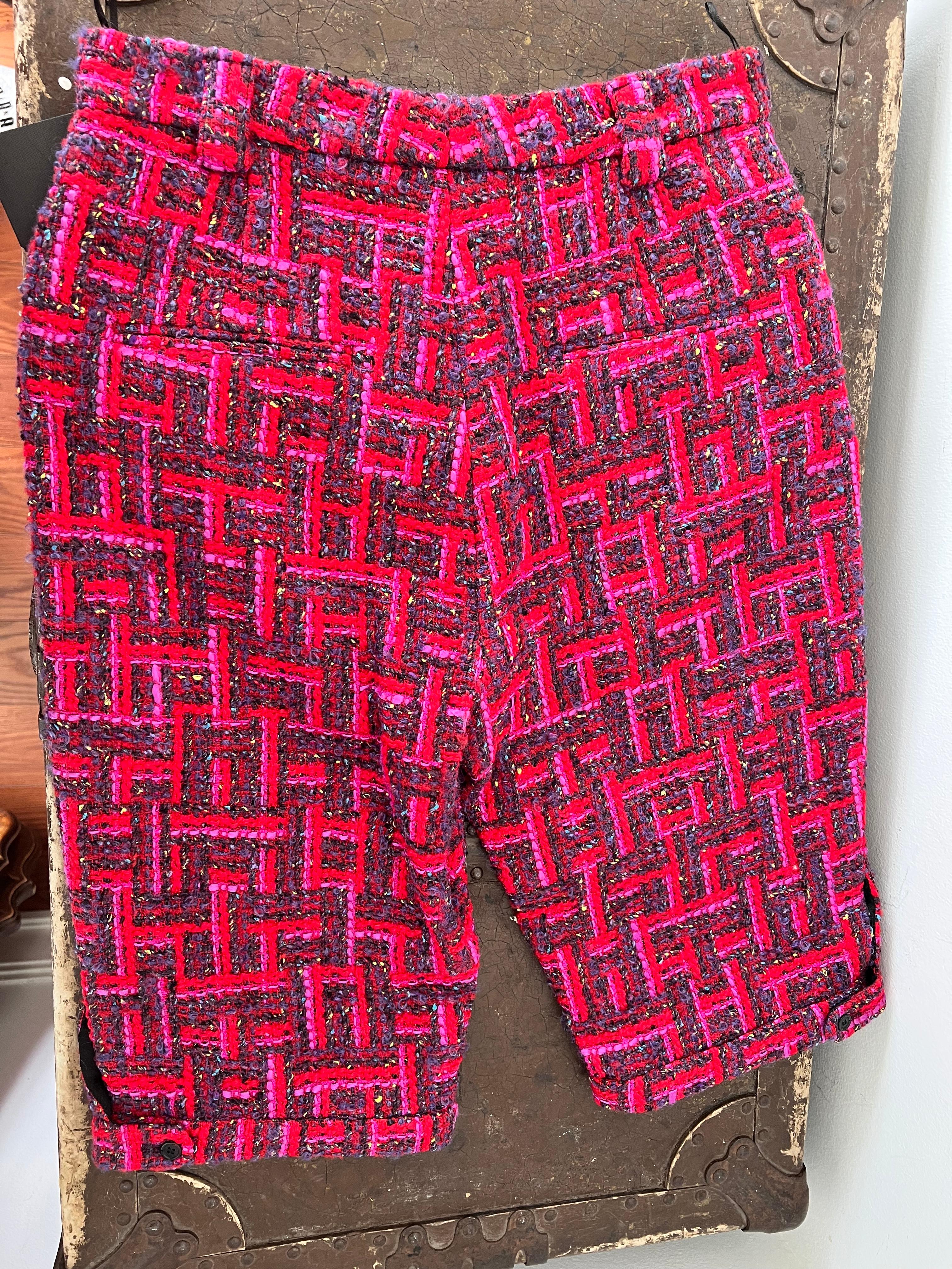 
Saint Laurent's Fuchsia Tweed Shorts, especially when brand new with tags, represent a perfect blend of sophistication and a vibrant pop of color. The house of Saint Laurent is known for its timeless elegance and cutting-edge style, and these