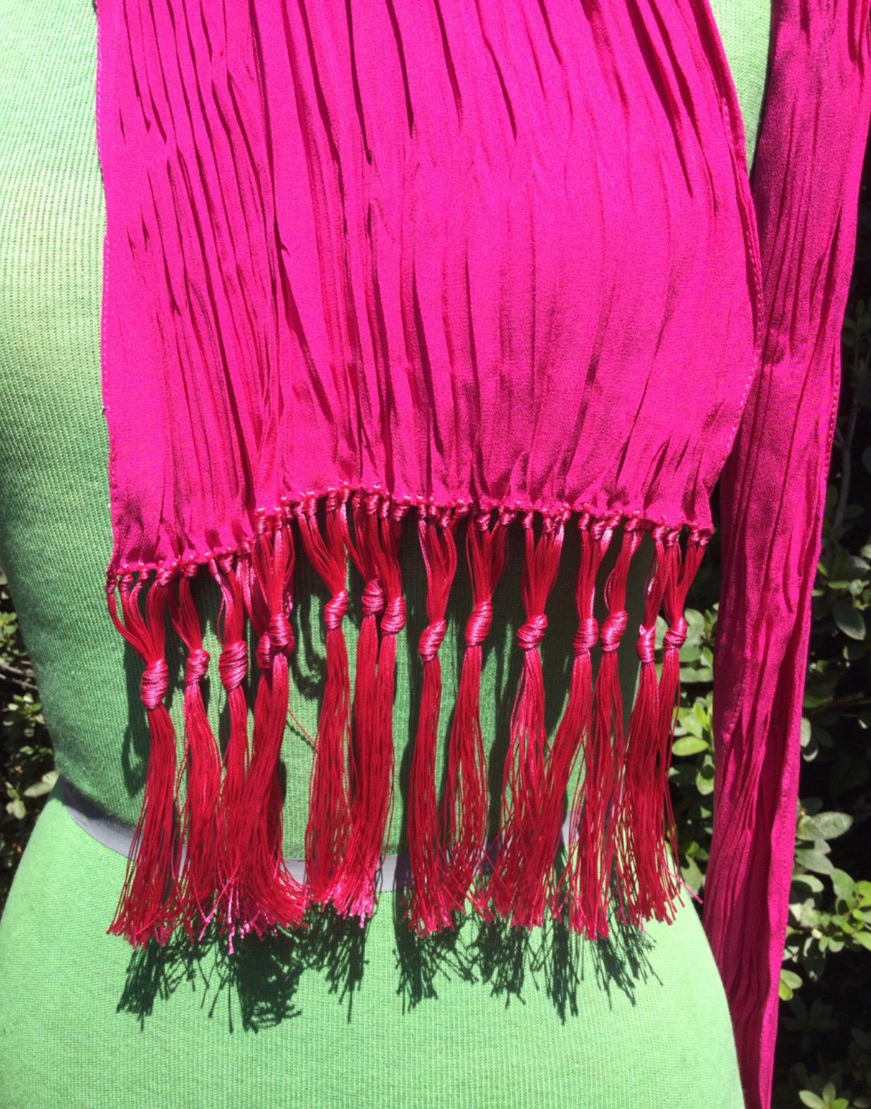 Saint Laurent fuchsia stole, with fringes. Featuring pleated texture. Length 224 cm, width 14 cm and open 44 cm, fringes 14 cm. The composition tag is missing but we think is silk. As good as new.
