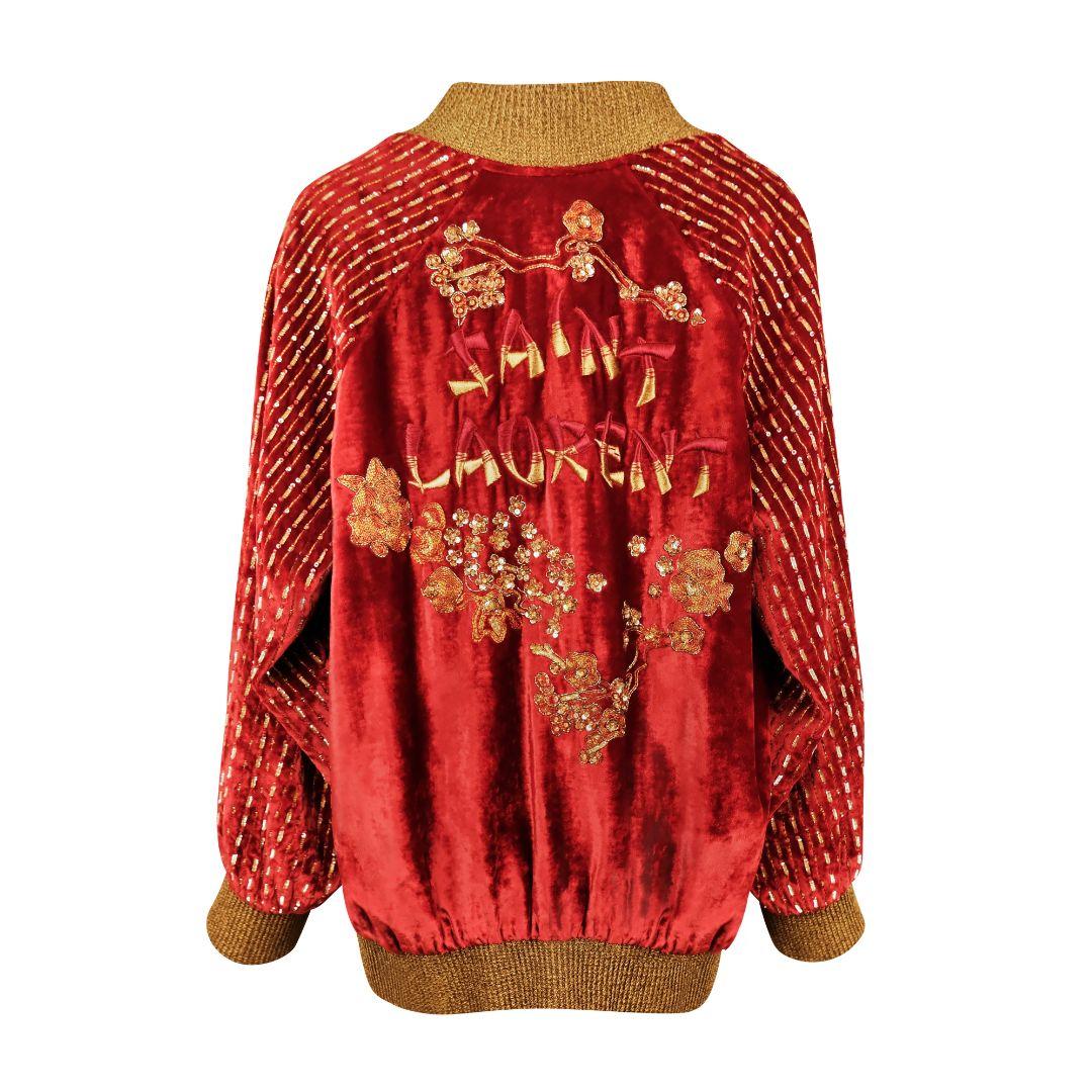 Saint Laurent Asian inspired velvet varsity jacket with intricate floral beading and sequin details with gold rib knit trim.

From the Fall/Winter 2019 collection by Anthony Vaccarello.

Oversized silhouette.

A large embroidered logo frames the