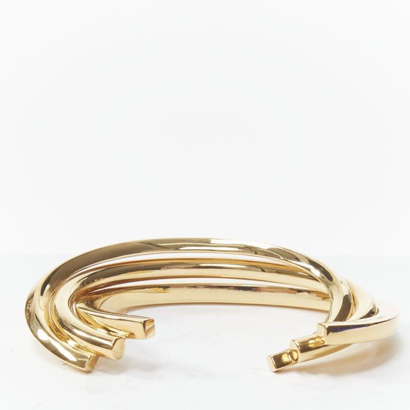 SAINT LAURENT gold tone architectural triple twist cuff bangle Hedi Slimane
Reference: TGAS/B01763
Brand: Saint Laurent
Designer: Hedi Slimane
Model: Triple twist cuff
Material: Brass
Color: Gold
Pattern: Solid
Extra Details: Hedi Slimane for Saint