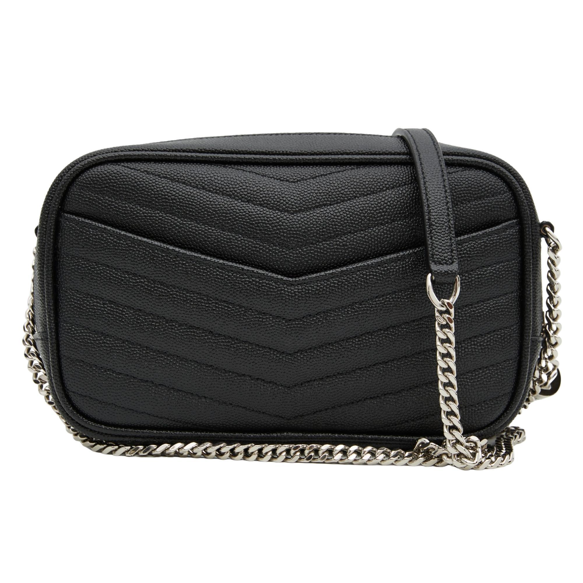 This shoulder bag is made of chevron-quilted calfskin leather in black. The bag features a silver chain link shoulder strap, and a matching silver YSL monogram detail on the front. The tasseled wrap-around zipper opens to a compact black leather