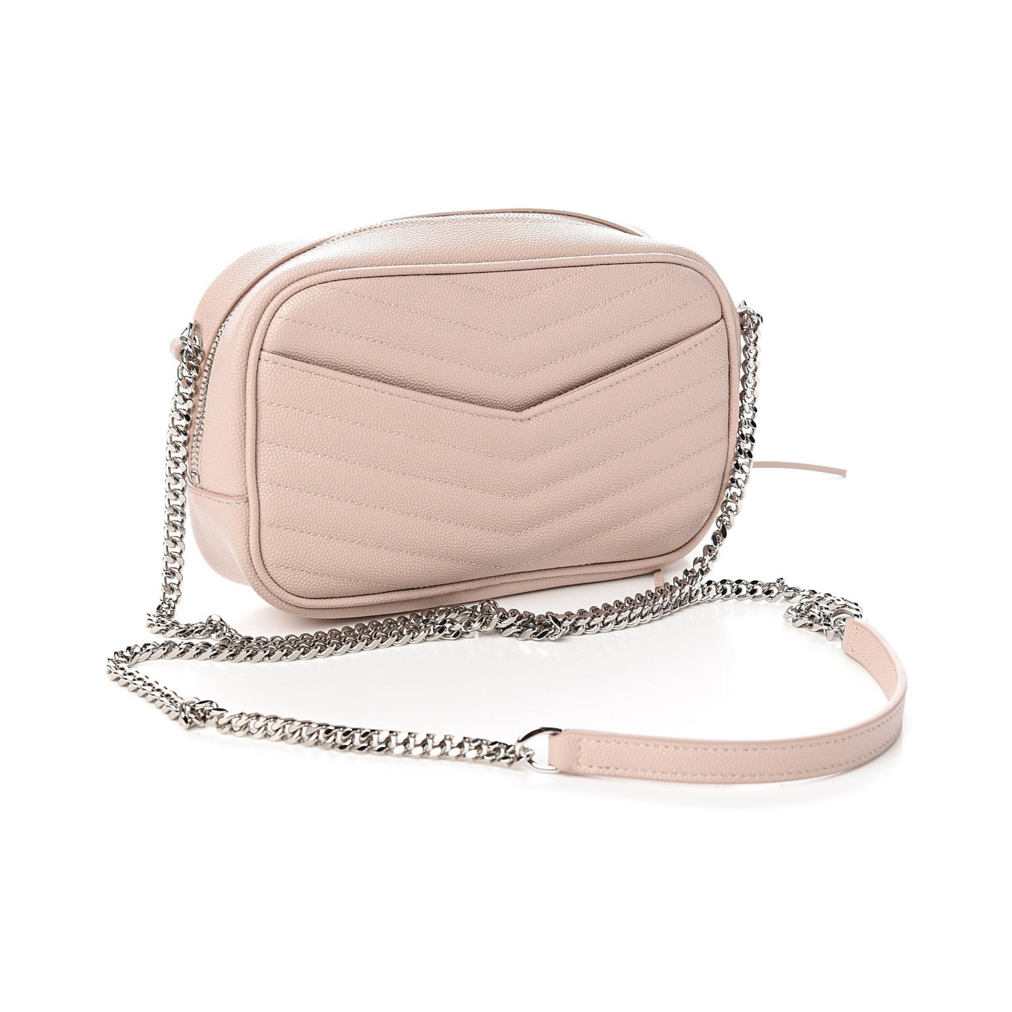 This shoulder bag is made of chevron-quilted calfskin leather in marble pink. The bag features a gold chain link shoulder strap, and a matching gold YSL monogram detail on the front. The tasseled wrap-around zipper opens to a compact black leather