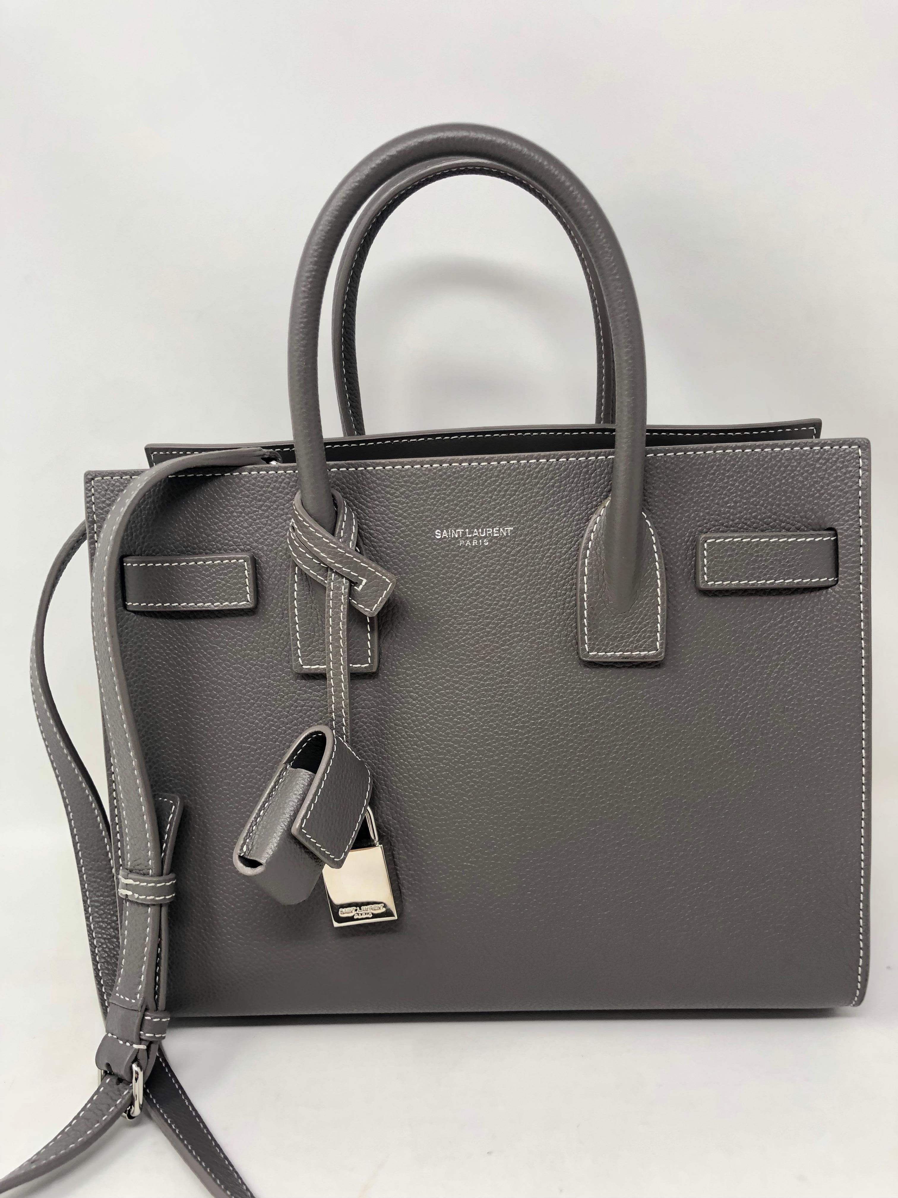 Saint Laurent Gray Baby Sac De Jour Bag. The mini size crossbody. New with tags, never used. Beautiful gray color in leather. Includes silver lock and key. Ready to be worn. Guaranteed authentic. 