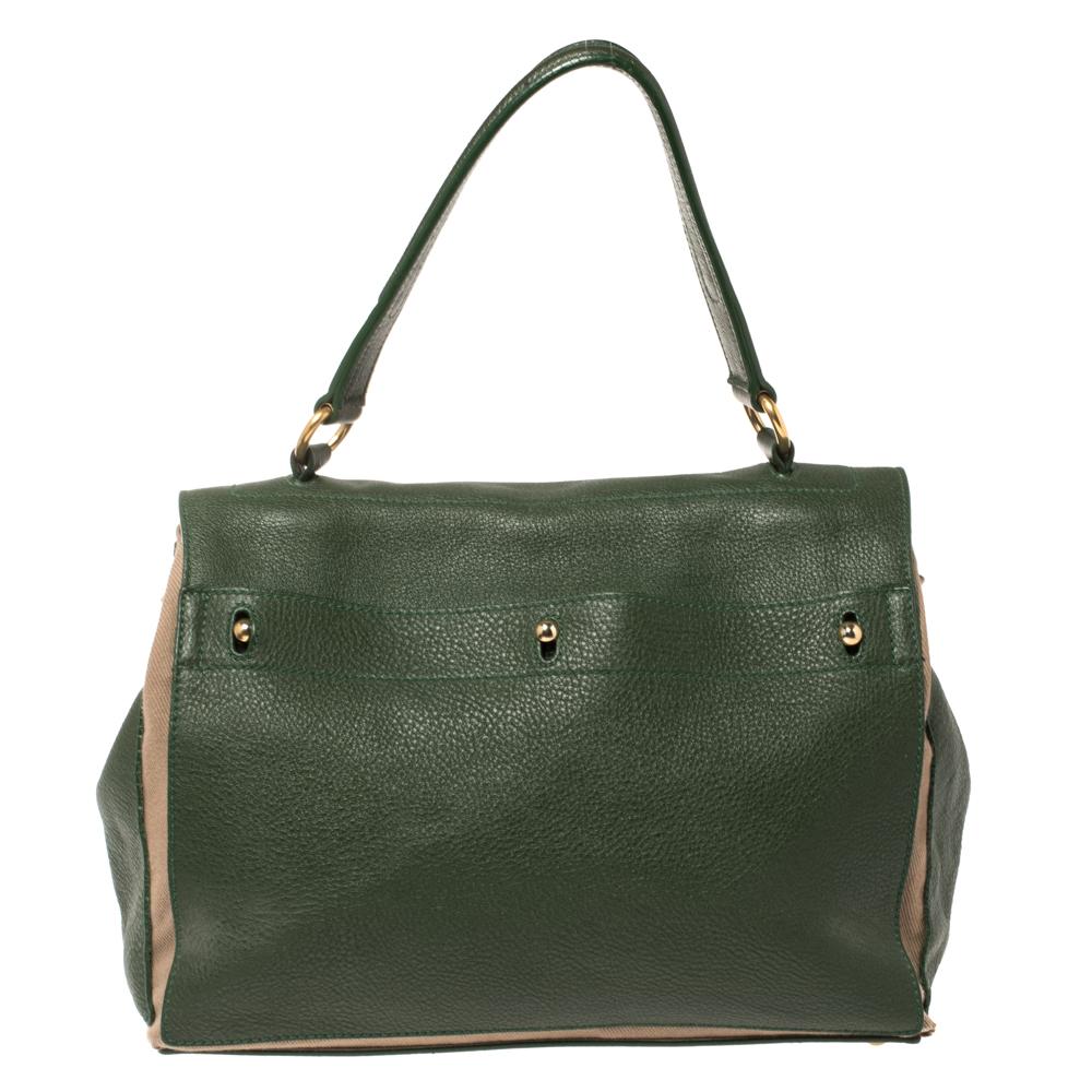 This bag, from the house of Yves Saint Laurent, is the epitome of utility and design. Elegance meets style effortlessly when you team up your outfit with this green & beige bag. This richly tailored fashionable leather & canvas bag is designed to